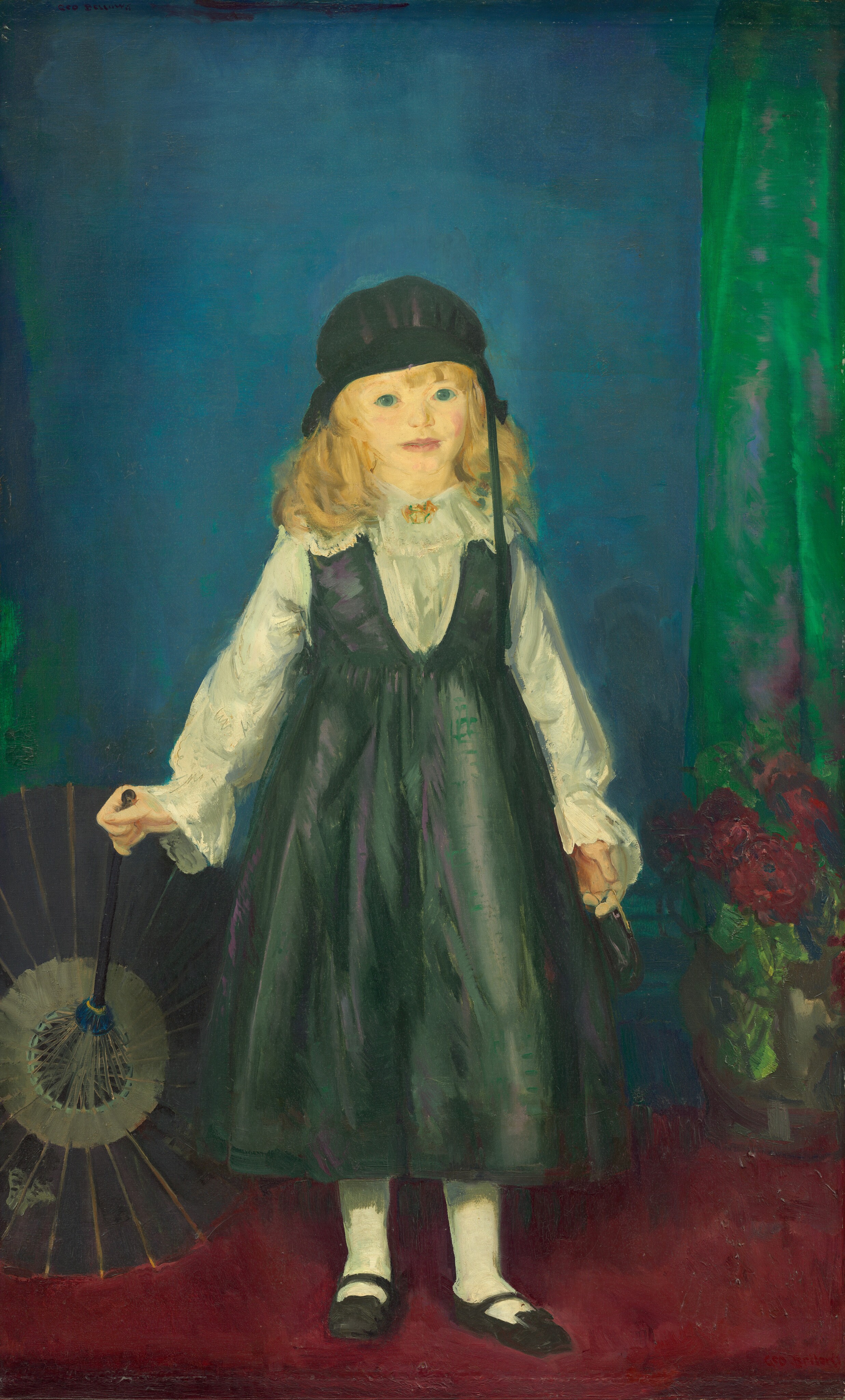 This painting shows a young girl standing and facing forward. She is holding an open, dark-colored parasol with one hand and a small, indistinct object with the other hand. She stands on a red carpet, and the open top of the parasol rests on the floor. The girl has pale yellow skin, bright blue eyes, and wavy blonde hair under a black cap. She is wearing a dark green pinafore over a white blouse with lace details, white stockings, and black shoes. In the background, there is a blue wall with a green curtain on the right side. A vase with red flowers is partially visible on the ground to the right.