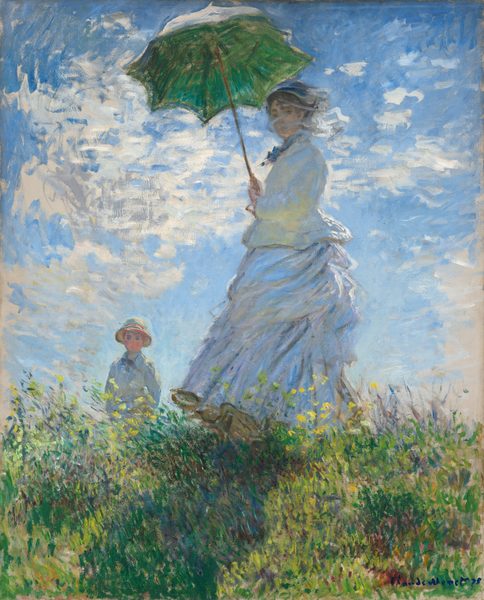 From low on a hillside, we look up at a light-skinned woman and boy standing in tall grass against a sunny blue sky in this vertical painting. The woman stands at the center of the composition, and the moss-green parasol she holds over her head almost brushes the top edge of the canvas. Her body faces our left but she turns her head to look at us. Her long dress is painted largely with strokes of pale blue and gray with a few touches of yellow. Her voluminous skirts swirl around her legs to our left. She holds the parasol with both hands, and her brown hair is covered with a hat. Long strokes of white paint across her face suggest a veil fluttering in the breeze. The tall grass she stands in is dotted with buttercup yellow and plum purple, and she casts a long diagonal shadow along the grass toward us. The young boy seems to stand on the other side of the hill, since the grass and flowers comes up to his waist. He wears a white jacket and pale yellow straw hat. His arms are by his sides, and he seems to look off into the distance to our left. A sunny blue sky behind the people is dotted with bright blue clouds. The painting is created with loose brushstrokes throughout, and they are especially choppy in the clouds. The artist signed and dated the painting in royal-blue letters at the lower right: “Claude Monet 75.”