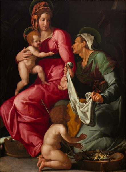 This painting shows four people: two adult women and two young children. On the left is a woman with pale skin and reddish-brown hair tied up with an orange cloth. She wears a bright pink gown that drapes over her body and is tied with a dark ribbon around her waist. She holds a nude child on her lap. The child also has light skin and reddish-brown hair. Both the woman and child have pale golden halos behind their heads, and they look to the right, towards the other woman. This woman is older, with tan skin and thin gray hair under a black and white cloth. She wears green and brown robes and holds a white cloth in her hands as she kneels and looks up at the woman in pink. She also has a golden halo around her head. In front of her is another nude child with curly brown hair who carries a thin golden cross balanced on their shoulder. This child kneels by the bottom right corner by a small fire and faces away from us. The ground is gray, and behind the women is black, with a dark column faintly visible on the right side.