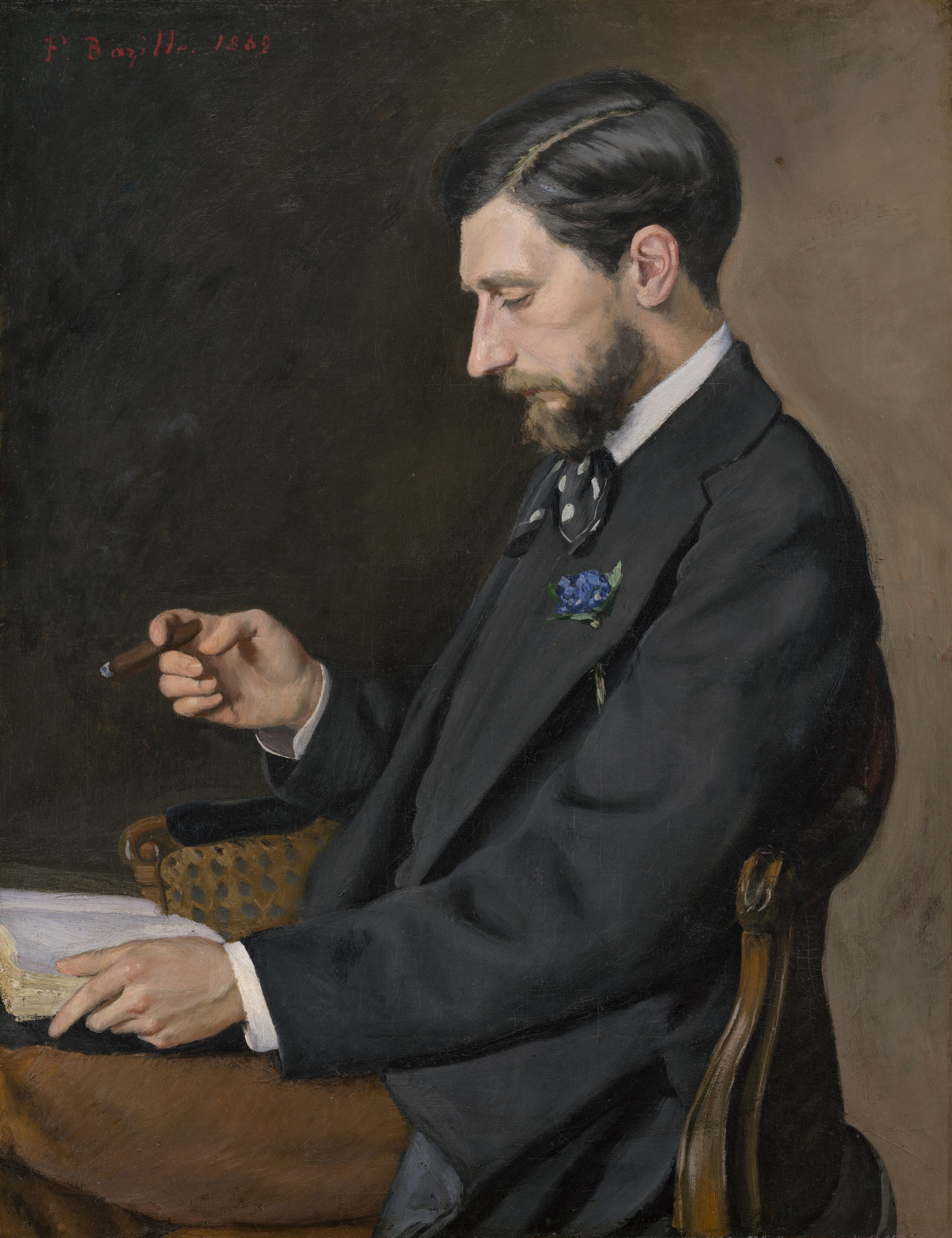 Shown from the lap up, a bearded, pale-skinned man wearing a suit faces our left in profile in this vertical portrait painting. The man looks down at an open book on his lap. He has a prominent, straight nose, high cheekbones, and the corner of his mouth turns down. His gleaming black hair is cut short and parted along the left, and his beard is trimmed. He wears a black vest and suit jacket, a black ascot polka dotted with white, and his white shirt is visible at the high collar and cuffs. A blue flower is threaded through his lapel, and he wears chestnut-brown pants. He holds one side of the book open with his left hand, closer to us, and holds a partially smoked, thin cigar with this other. The wood-framed chair has a curved, round-topped back. The background deepens from peanut-brown along the right to almost black near the top left corner. The artist signed and dated the painting at the top left, “F. Bazille. 1869.”