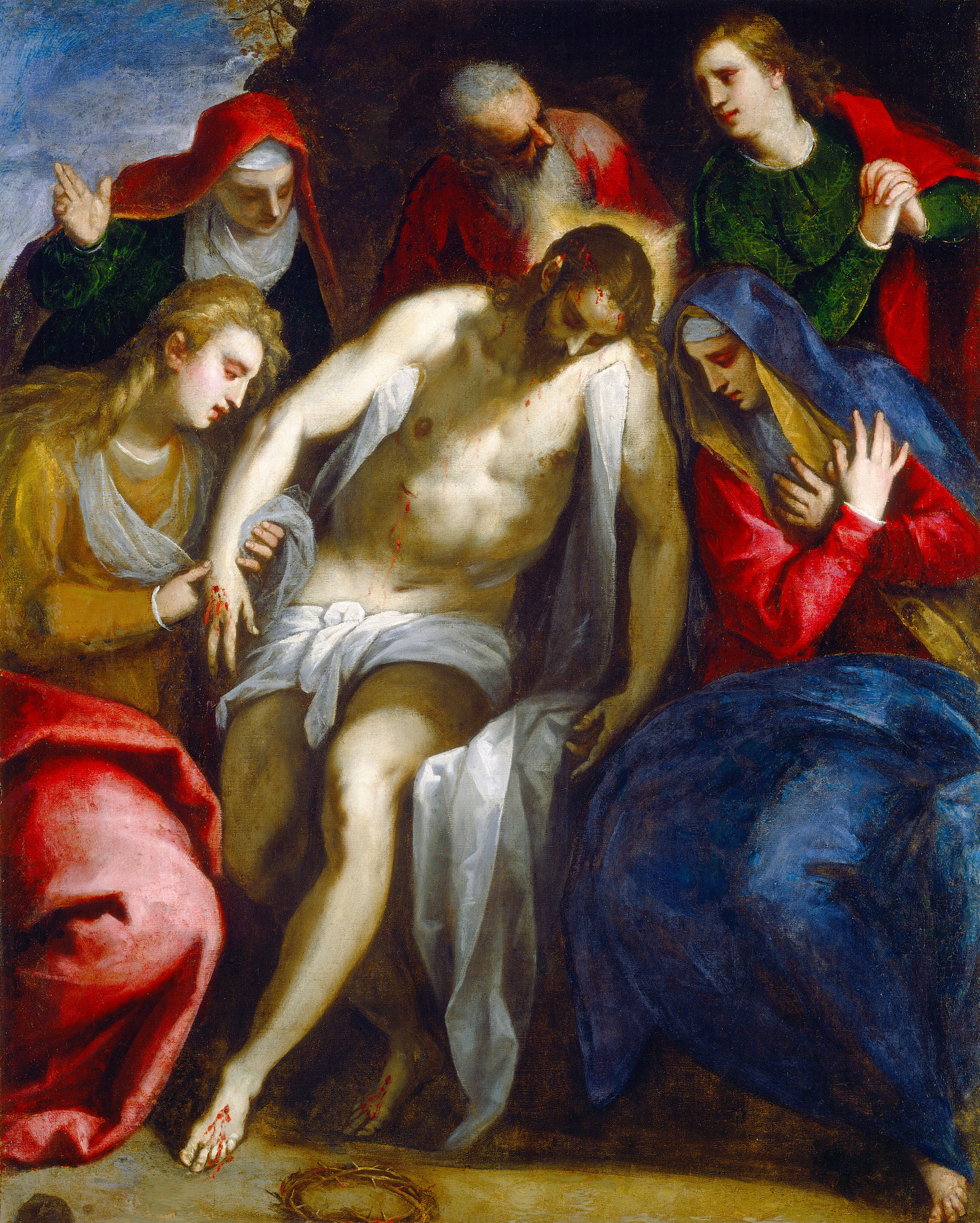 This painting features a group of individuals surrounding a man. He is seated, supported by the others. The man has pale skin, long dark hair, a dark beard, and eyes that appear closed. He is nude except for a white cloth around his waist and two more hanging from his shoulders. Blood is dripping from his forehead, his hands and feet, and a cut along his torso. A halo of yellow light shines from behind his head. Surrounding him are five people with pale skin and various hairstyles, all wearing richly colored garments. Two of them seem to be women with their heads covered. Two more seem to be young men with long, flowing hair. The fifth is an old man with gray hair and a gray beard, standing behind the central man. The background is dark, with a small patch of blue sky visible near the top left corner, and the ground below the group is brown, with a circle of thorny branches sitting by the feet of the central man.