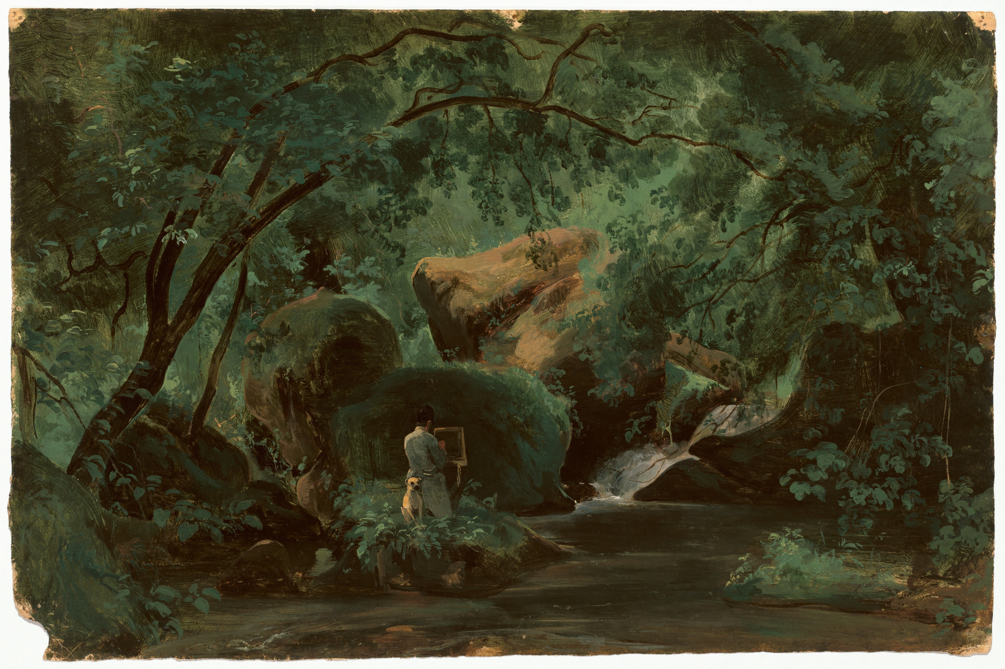 Boulders hulk at the center of a dense forest in this horizontal landscape painting on paper. A clearing along the bottom edge of the composition leads to a person facing away from us while standing at an easel. One hand is lifted to the canvas or paper on the easel, and the person wears a light gray coat. A light brown dog sits attentively at the artist’s back. Sunlight falls from an unseen opening in the canopy onto the boulders, which glow caramel brown and slate gray, and trees curve up and over to enclose the artist and rocks. The scene is loosely painted in earthy greens, and brushstrokes are especially visible in the boulders and the vegetation making a screen in the background.
