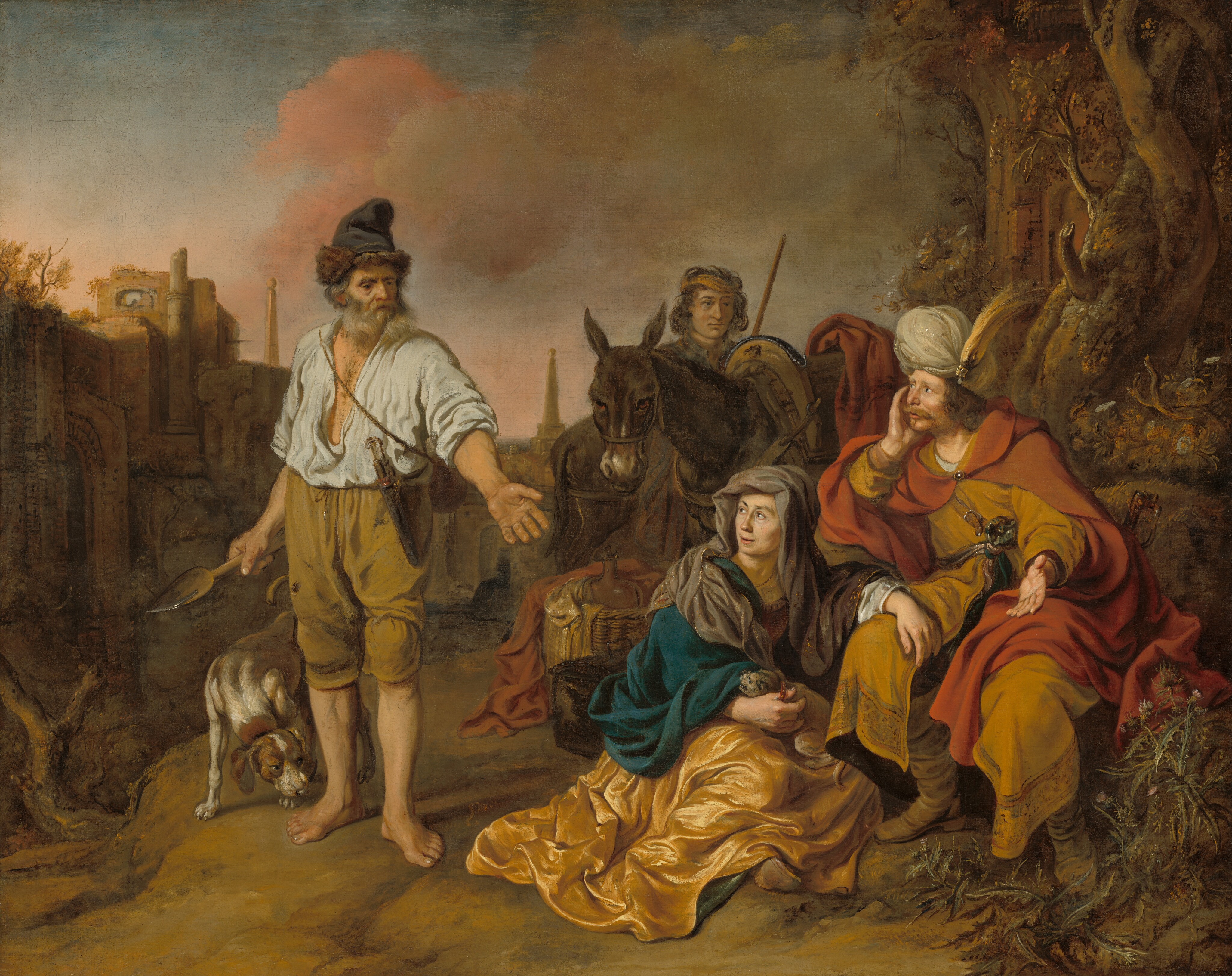 Four people, a dog, and a donkey are gathered next to a copse of trees and in front of a run-down town in the background in this horizontal painting. All the people have pale skin. To the left, a barefoot man with a long gray beard and a fur-trimmed cap stands holding a tool in one hand and his other extended toward the other people. He wears a loose white shirt, and a dagger hangs from the waist of his tan, knee-length pants. A brown and white dog sniffs, with head lowered, one of the man’s bare feet. The man’s face is heavily lined and he looks at the second man and a woman in the lower right quadrant of the painting with deep-set eyes. There, a man wearing a harvest-yellow robe under a red cape and a feathered, jeweled turban sits on a rock. He looks back at the first with his head resting in one hand and his other hand held up. This second man has chin-length, wavy brown hair and a dark blond mustache and thin beard. A rosette or other object is tied at his waist, and the hilt of a sword is visible behind his hip. The woman sits on the ground next to him, one arm draped over his lap. She wears a gray headscarf and a teal cloak over a golden yellow dress. The thumb on her other hand is hooked through the red, studded collar of a tiny gray dog in her lap. The dog bares its teeth at the first man. A wooden casket and a basket holding cloth and a jug are just behind the woman. Behind that are two donkeys and the fourth person, a clean-shaven man who peers over the donkeys’ backs at the seated man. Trees to the right grow up around a mostly hidden structure. Grasses and plants grow along the ruined rooflines of the town behind the first man. A bank of khaki-brown and carnation-pink clouds billow up in the sky above, which deepens from pale blue along the top of the canvas to pale petal pink along the horizon.
