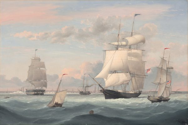 This painting shows a seascape with large sailing ships and smaller vessels. To the right of center is a large ship with several tall masts and many billowing white sails. The body of the ship is black, and a long point extends out from its front. Silhouettes of small people are visible across the large deck. Another large vessel is visible on the far left, while three smaller boats with fewer sails can be seen to the left of center and on the far right. The ships all fly flags, including red flags, blue flags, and red-and-white striped flags with sections of blue in the top left corners. The wavy sea below the boats is gray, with a darker section towards the bottom of the painting and a lighter section towards the horizon. A small wooden barrel floats in the sea towards the bottom of the painting. The sky is light blue, and puffy, pale pink clouds drift across it. Beyond the ships, a distant shore is visible, dotted with more white sails, gray smokestacks, and dark gray buildings.