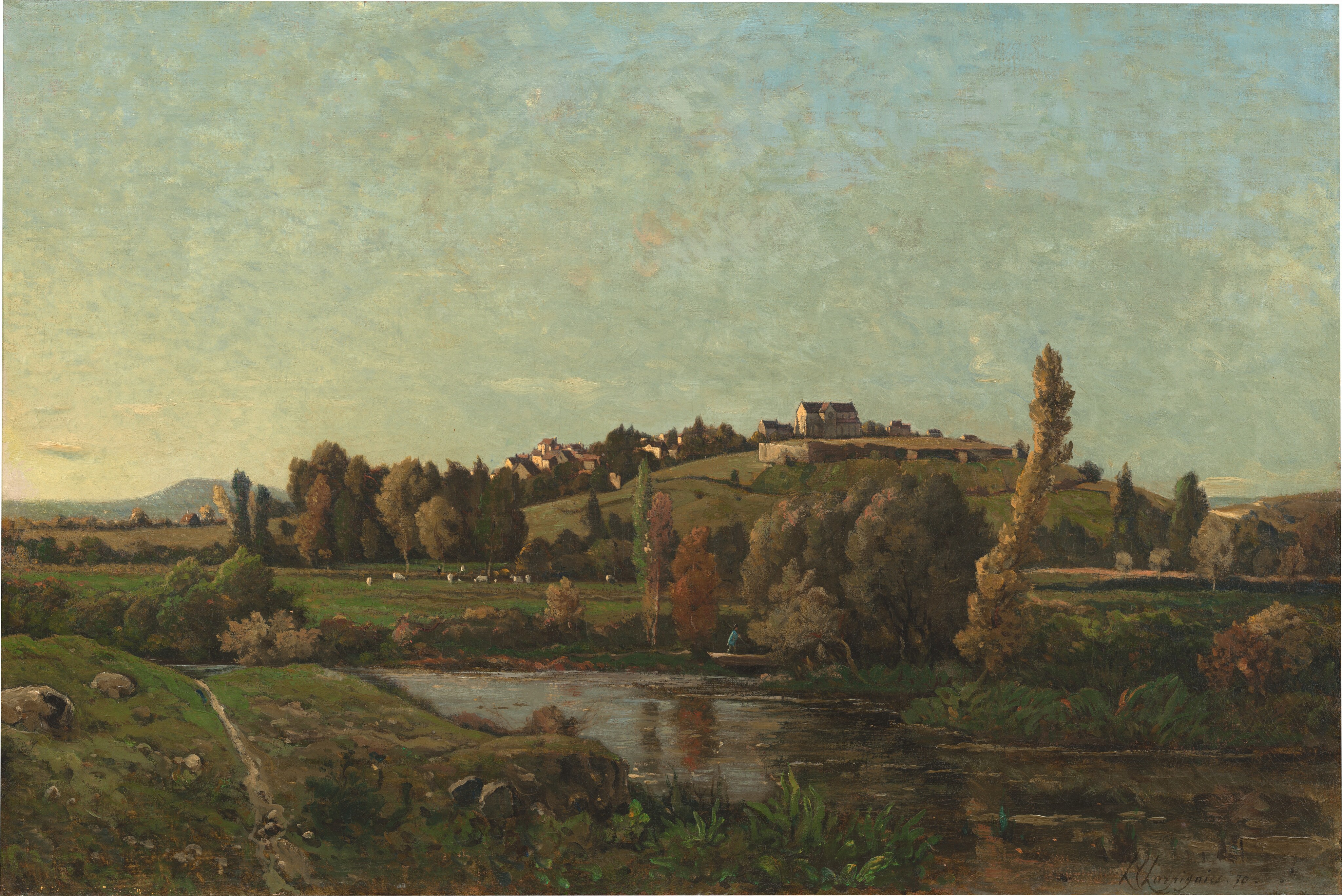The painting depicts a rural landscape from a distance, showing a hill, houses, and trees. At the bottom of the painting is a body of water with two green banks on either side. The water reflects the green surroundings. On the right, a grassy path with rocks cuts across the landscape. Behind the water is a hill in the distance, with several small buildings on its top. At the base of the hill are several small figures on a grassy field, perhaps a mixture of humans and animals. The colors are predominately shades of green and brown, with some hints of rusty orange. The sky takes up the top half of the image and is a light blue color. Light brushstrokes are visible in the sky.