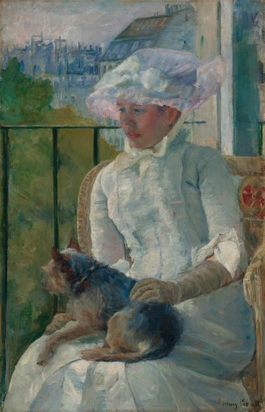 Shown from the knees up, a young woman wearing a white gown and bonnet sits in front of a balcony railing on a sunny day, holding a small dog on her lap in this vertical portrait painting. The scene is painted with visible brushstrokes, which are especially broad in the background and clothing. The woman sits with her body angled to our left, and she looks down in that direction with blue eyes. She has a short, snub nose, rosy cheeks, and her full, pink lips are parted. The woman’s bonnet is tied under her chin with a pale yellow bow. Her dress has a tightly-fitting bodice, elbow-length sleeves, and a long skirt. The bonnet and dress are painted with strokes of faint sky blue, petal pink, lavender purple, and mint green, with cream-white highlights and some darker cobalt-blue and apricot-peach strokes for shading. The dog on her lap lies with its head to our left, lifted as it looks out onto the landscape. The tan glove the woman wears on the arm we can see reaches her elbow, and she rests that hand on the dog’s back. Her right arm, to our left, is hidden below the elbow by the dog. The animal has charcoal-gray fur along its back and tan fur on the legs and shaggy face. The woman sits in a wicker armchair with a crimson-red medallion next to her left shoulder, to our right. The black balcony railing spans the width of the painting at the level of her nose, and has vertical bars. In the landscape beyond, trees to the right are painted loosely with sage green and mustard yellow. Buildings in the distance fill the top quarter of the composition, and are loosely painted with strokes of slate and aquamarine blue. The sky above is streaked with pale blush pink and ice blue. The artist signed the painting in the lower right corner, “Mary Cassatt.”