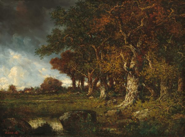 This painting shows a woodland scene with dense trees on the right side, their white and brown trunks twisting upwards and their leaves in shades of dark green, yellow ochre, and rusty orange. In the bottom left corner, a small reflective body of water is visible behind dark stones nearby. Behind the water is a low green meadow with tall grass, and in the distance there are more tall trees and some white buildings with red roofs. The horizon is visible on the left, separating the ground from the blue sky. There are bright white clouds near the horizon, but in the upper left corner are dark gray clouds.