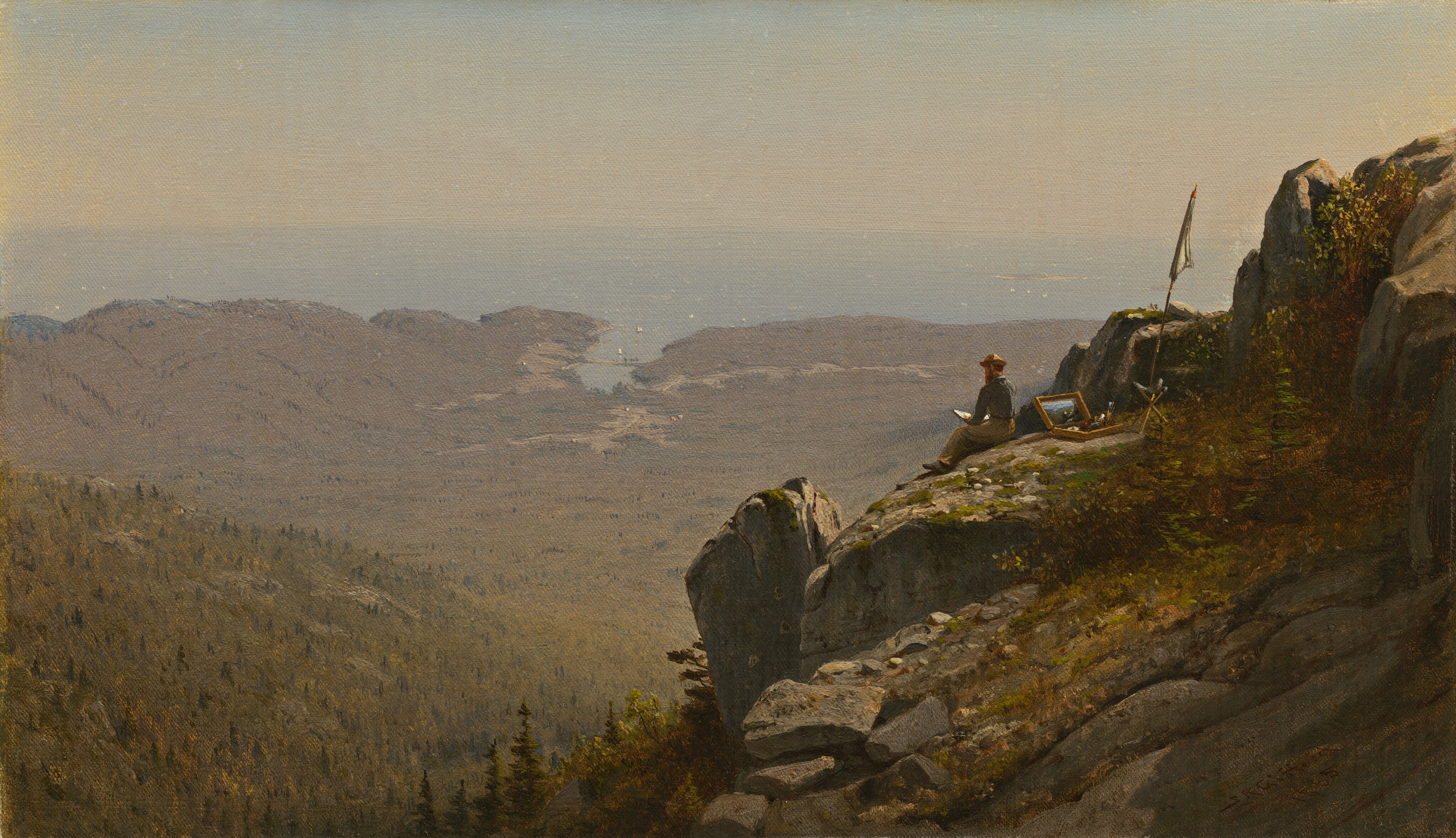 A man sits on a sheer, rocky outcropping high above a sunlit expanse of land that stretches to meet a sun-dappled sea in this horizontal painting. The outcropping slopes in to fill the right half of the composition, and is partially carpeted by mustard-yellow, brown, and moss-green growth. Bright sunlight from the upper right glints off some of the craggy, steel-gray rock faces. The man is tiny in scale within the composition, and sits near the top right with his legs stretched out in front of him. He wears a denim-blue shirt, tan pants, and soft hat with a narrow brim. He appears to have red hair and a beard. He holds a white object in front of him, presumably paper or a notebook. Behind him an open box of paints and brushes sits near a camp stool with a closed white parasol planted next to it. A lower hill in the middle distance slopes in from the left side and disappears behind the outcroppingin the center of the composition. The hill is covered with muted and dark greens and yellows, suggesting a forest of pine trees. The hill descends to meet the flat, mauve-tinted land, which is crisscrossed with shallow fissures. In the distance, the area where the narrow band of powder-blue sea meets the sky, about three-quarters of the way up the canvas, is painted with a tan-colored haze. The artist signed the work in the lower right as if he had carved his name and the date into the rock. It reads, “S R Gifford 1865.”