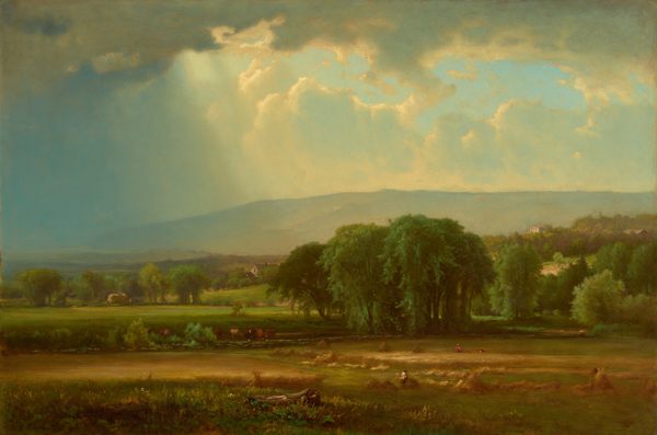 This painting depicts a vast countryside from an elevated point of view. At the bottom of the painting is a wide brown and green field that appears to be growing wheat or a similar crop. Small people appear to work the field, gathering the material into piles. Brown and white cows graze in a green area behind the field. A stand of tall, dark green trees sits in the middle of the painting, behind the field. In the distance there are rolling green hills with small white buildings scattered around them. Behind these hills lies a tall, light blue mountain. Most of the top half of the painting is taken up by a wide blue sky packed with gray and white clouds. A ray of light shines between the clouds and illuminates the field below.