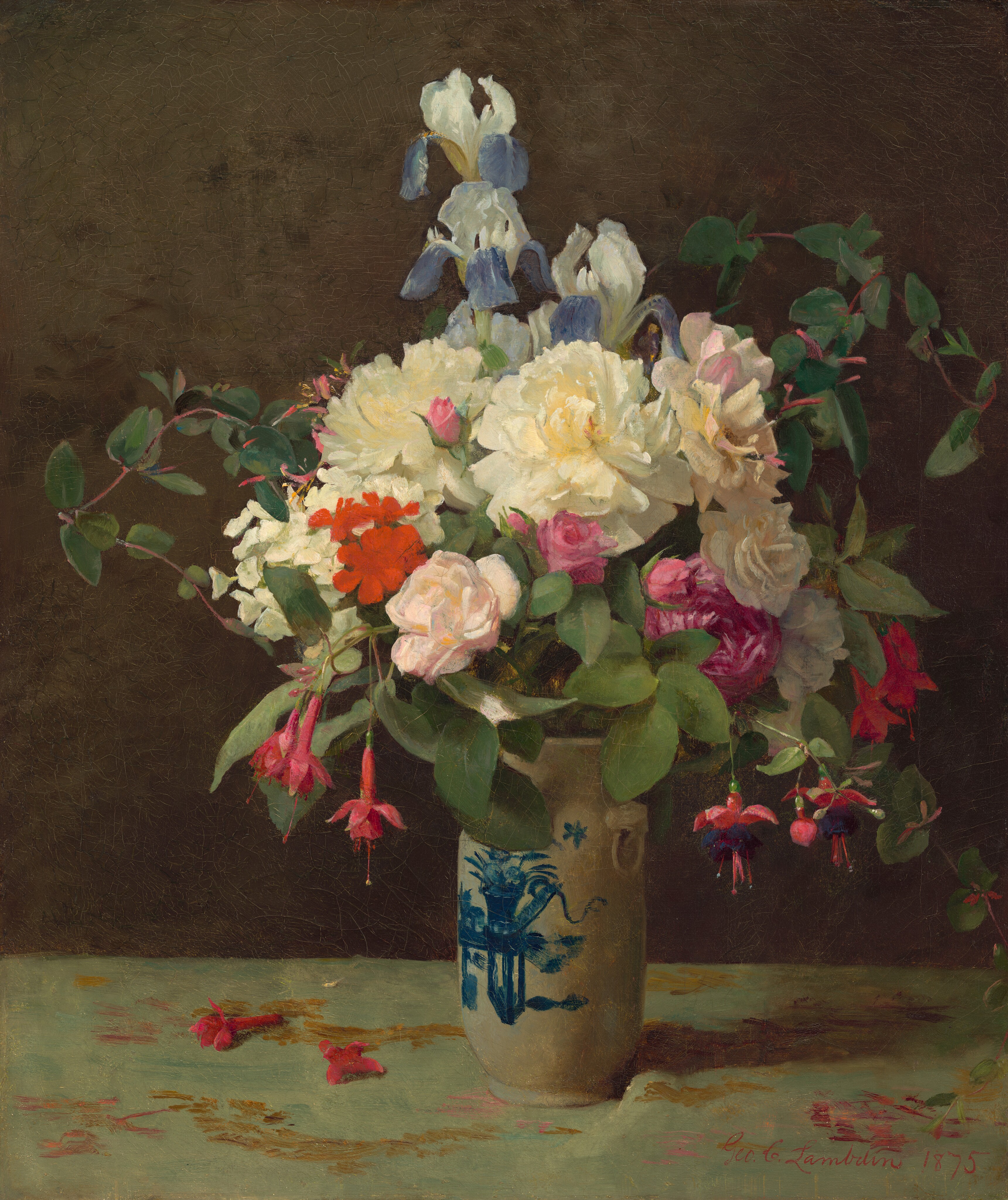This painting depicts a large ceramic vase filled with various flowers such as white peonies, blue and white irises, pink roses, and red fuchsias. Between these flowers are dark green leaves. The vase is white with a blue decorative design, and it sits on a pale green cloth with gold patterns. Some scattered pink petals rest on the cloth around the vase. The wall behind the vase is dark brown.
