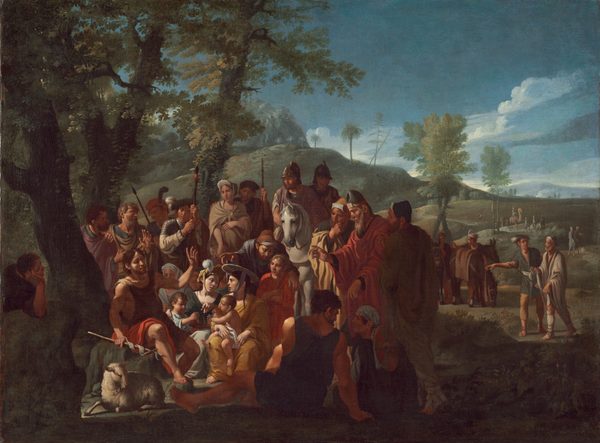 This painting shows a group of people in a forest. They are closely gathered, some seated on the ground, others standing, and a few mounted on horses. The person in the center of the group is seated on the left, dressed in colorful attire and raising one hand up while holding a small cross wrapped in fabric in the other hand. Surrounding them are men, women, and children of varying ages wearing cloaks or simple garments, some with hats or headscarves. Their expressions vary, some turning to speak to one another. Many people hold tall staffs. Around the group are tall trees, and to the lower left is a resting sheep sitting beside the central person. The background shows a landscape with distant hills, sparse green trees, and open blue sky with wispy clouds. There are scattered people and livestock in the fields on the right.