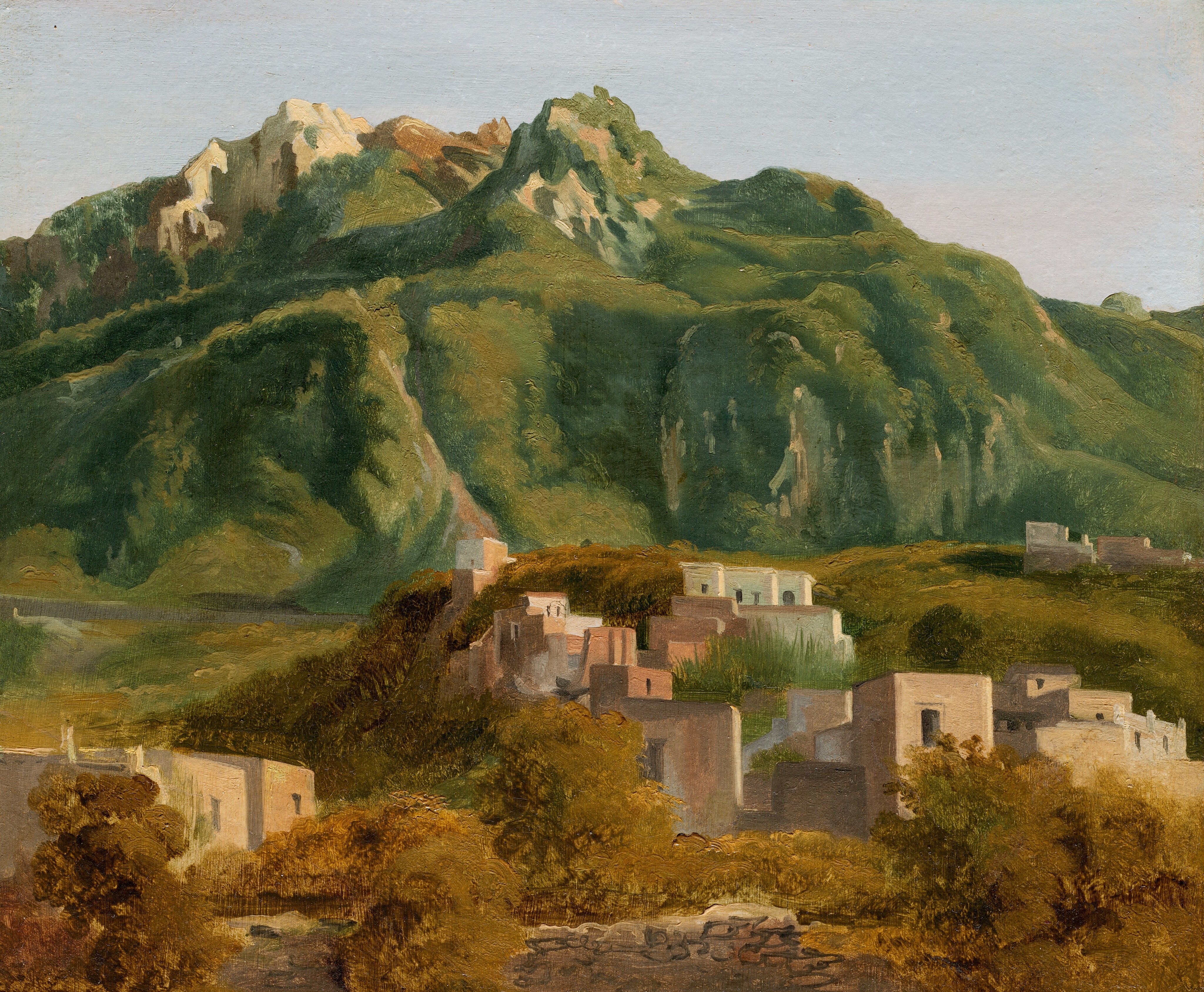 This painting shows a landscape with tall green mountains filling the background. The mountains have gray, rocky peaks, above which is a strip of light blue sky.  At the base of the mountains, small, square buildings in shades of white, gray, and faded terracotta sit on small hills among light brown and olive-green plants.