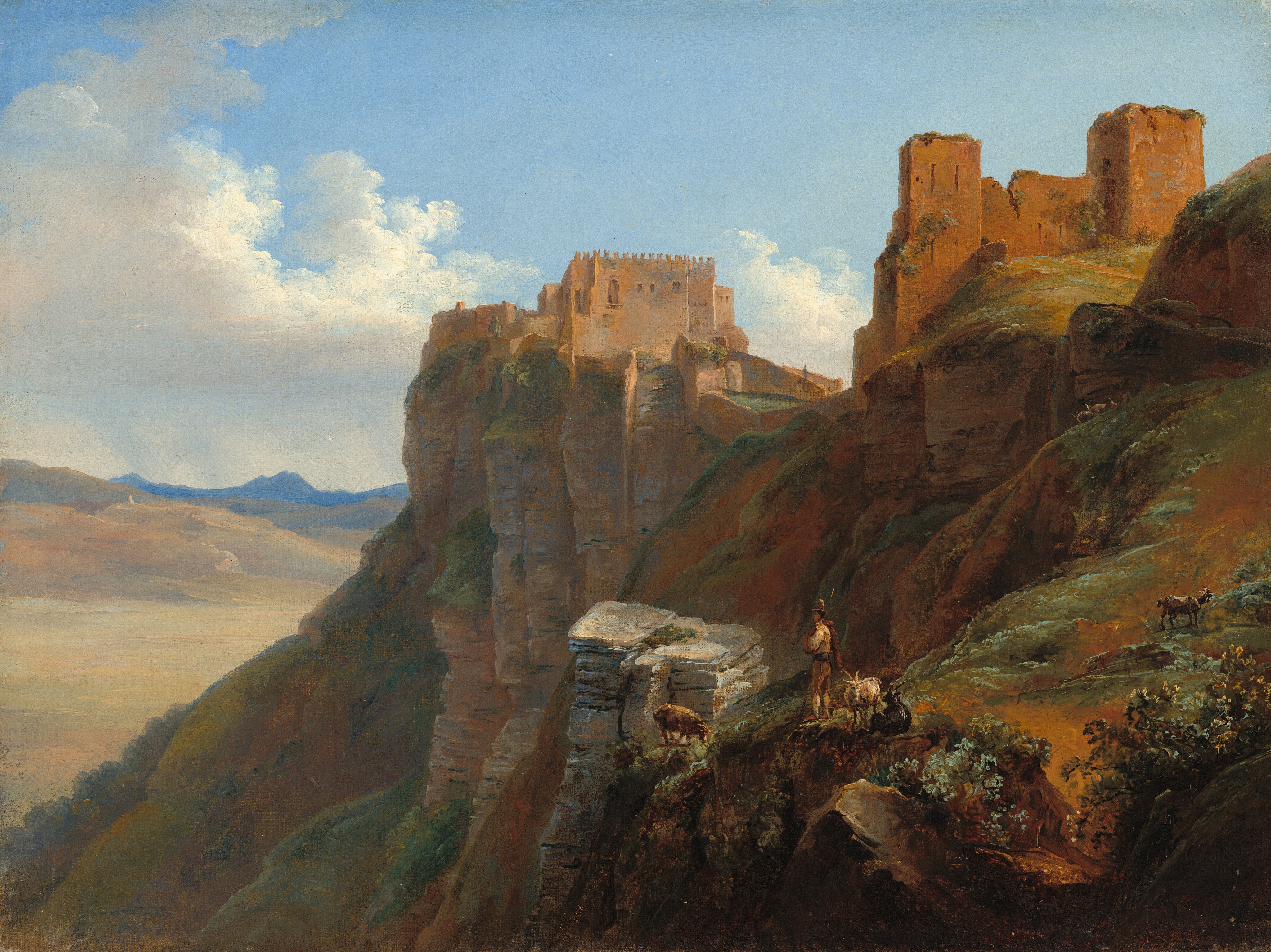Steep, rocky cliffs span the right two-thirds of this horizontal painting in front of a distant landscape to the left. A brown stone fortress or castle, with crenellated walls and few visible windows, is built at the edge of the cliff at the center of the image. To the right and higher up on the hill are more reddish-brown stone ruins with tall, narrow towers, also partially overgrown with vegetation. Closer to us and in the bottom right corner of the painting, a person with light skin wearing a brimmed hat and tan and brown clothing stands among several goats and looks out to the left. Some goats graze or stand on the rocky path near the person, while others are scattered farther across the sloping, grassy terrain. The rocky hillside is dotted with patches of green vegetation and shrubs. The base of the cliffs fade in the near distance and beyond them is a wide, hazy valley or plain under a blue sky filled with soft, white clouds. Streaks over mountains along the horizon, which comes halfway up the composition, suggest distant rain. A black mark in the lower right corner could be the artist’s initials, JS, conjoined as a monogram.