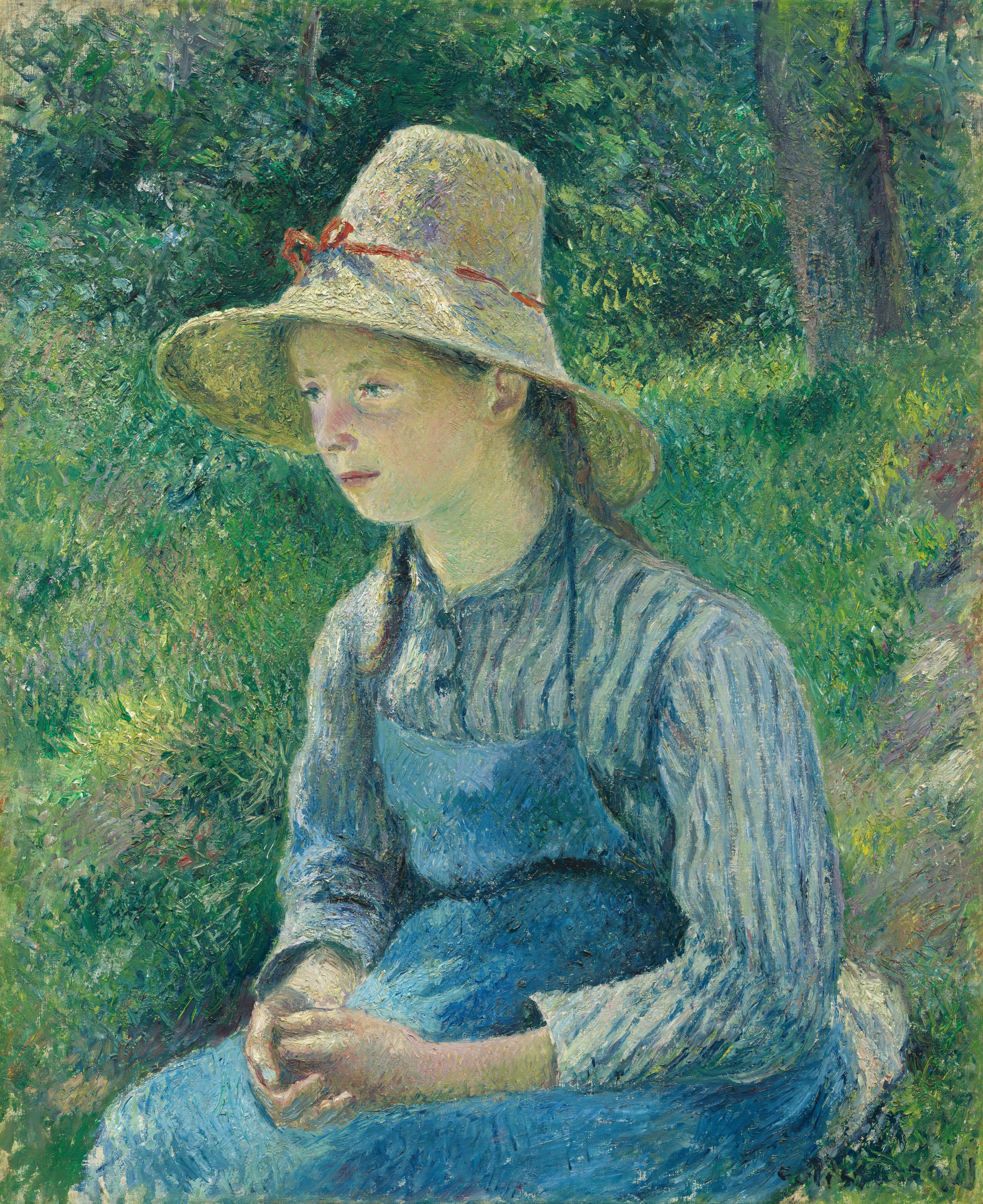 Shown from the lap up a pale-skinned young girl sits in a grassy landscape in this vertical painting. The girl and surroundings are painted with visible strokes and dashes of mostly vivid greens and blues, which give the scene a soft look. The girl sits angled to our right and she looks off in that direction from heavy-lidded, aqua-colored eyes. She has an oval face, full cheeks, and a round chin. The bridge of her nose is touched with pink, and the shadows under her chin are tinged with green. Her brown hair is mostly covered by a wide-brimmed straw hat tied with a thin brick-red ribbon around the base of the high crown. She wears a sky-blue pinafore over a long-sleeved, collared shirt with vertical light and dark blue stripes. Her hands are folded loosely in her lap. The background is filled with dappled greens and hints of shadow, suggesting filtered sunlight and trees, though the forms are not sharply defined.