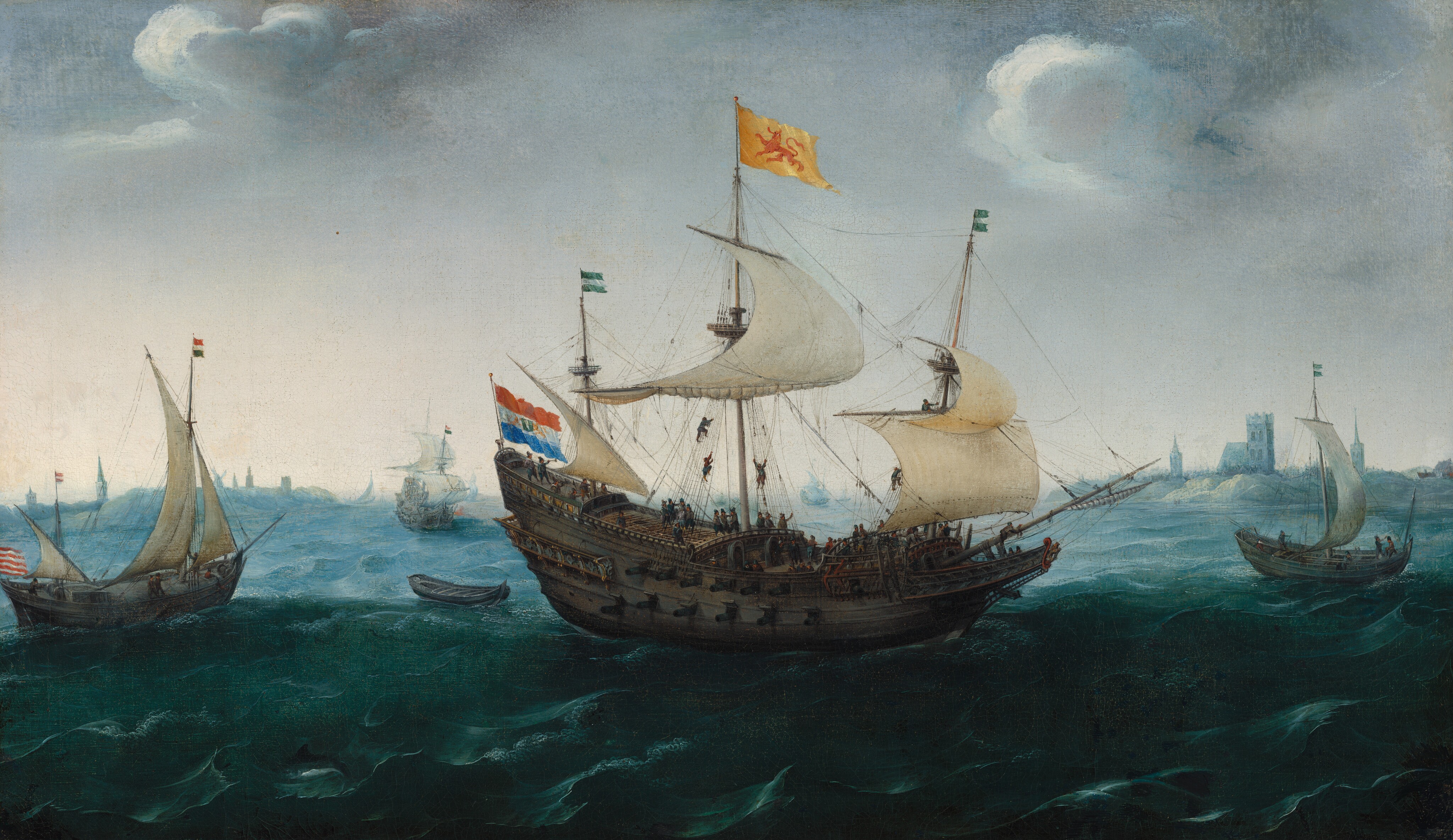 The painting depicts a seascape from an elevated perspective, showing a low horizon line with large ships sailing on the water. In the center is the largest ship, with four sails and several colorful flags, including one with horizontal stripes of red, white, and blue, and one large golden flag with a red animal that looks like a lion. Countless small people are on the deck of this boat, with some climbing ropes to get to the different sails. In the background are other ships, with a few smaller sailboats and one rowboat. On the horizon are the indistinct blue outlines of buildings on a far-off coastline. The ocean is rough, with large, dark blue waves topped with white surf. The sky is dark and stormy, with dark gray clouds at the top fading to a lighter gray near the horizon.