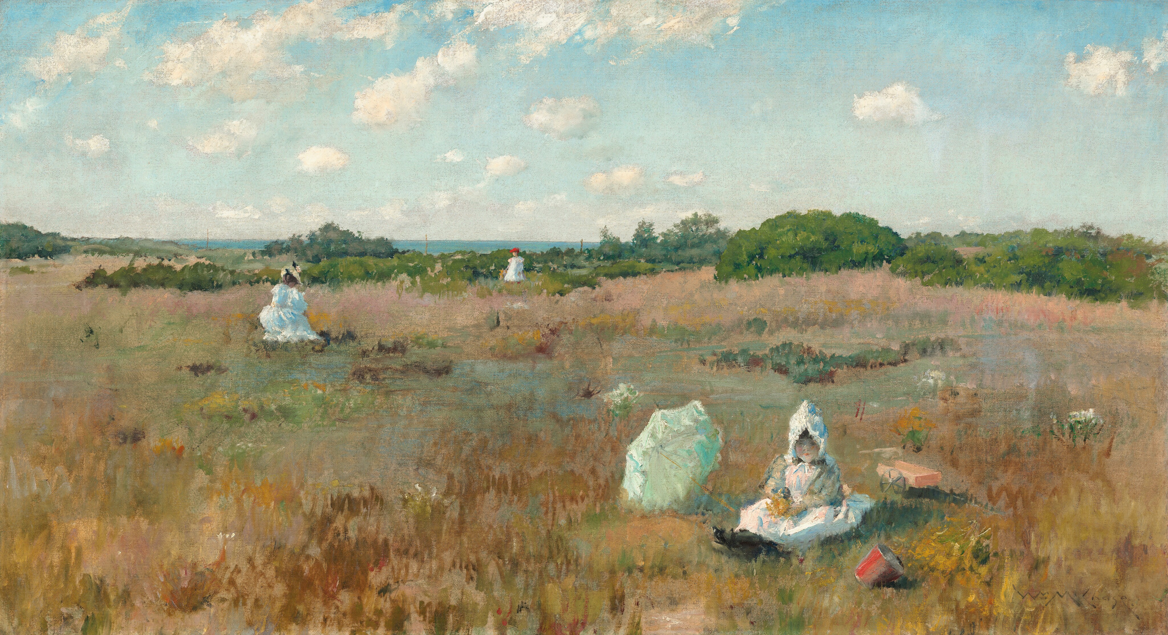 The painting depicts a golden, grassy landscape with low green trees in the distance, leading towards vibrant blue water on the horizon. The field is streaked with patches of brown, light pink, light blue, rusty red, dark green, and dark red. People dressed in white are scattered throughout the field; closest to us, on the right, a child sits in the grass next to a pale green parasol. The child has pale skin, rosy cheeks, and dark hair visible under a white bonnet. They wear a white gown and black shoes, and they hold something yellow on their lap. In front of them is a red bucket, and behind them is a small orange cart. Farther away from us, on the left, a woman in a long white dress and a tan hat kneels or sits in the grass, and to the right another person stands even farther away near the low green trees, wearing a white dress and a red hat. The sky above is light blue, with soft, fluffy white clouds drifting across it. The painting employs soft, loose brushstrokes.