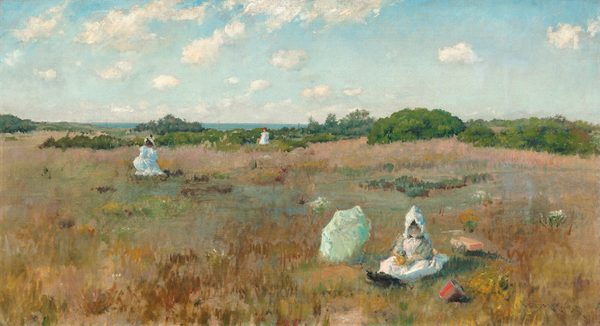 The painting depicts a golden, grassy landscape with low green trees in the distance, leading towards vibrant blue water on the horizon. The field is streaked with patches of brown, light pink, light blue, rusty red, dark green, and dark red. People dressed in white are scattered throughout the field; closest to us, on the right, a child sits in the grass next to a pale green parasol. The child has pale skin, rosy cheeks, and dark hair visible under a white bonnet. They wear a white gown and black shoes, and they hold something yellow on their lap. In front of them is a red bucket, and behind them is a small orange cart. Farther away from us, on the left, a woman in a long white dress and a tan hat kneels or sits in the grass, and to the right another person stands even farther away near the low green trees, wearing a white dress and a red hat. The sky above is light blue, with soft, fluffy white clouds drifting across it. The painting employs soft, loose brushstrokes.