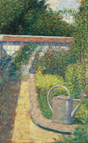 The painting features a large gray watering can in the bottom right corner, set against a lush garden background. Bushes on the right side are speckled with dots of pink, yellow, blue, orange, and purple, suggesting flowers. A dirt path extends from the bottom left up towards a white wall that stretches horizontally across the scene. The watering can rests on the edge of the path. Above the wall are more dark green trees with a small patch of light blue sky. The paint in this image has been applied with small, visible dots and short brushstrokes.