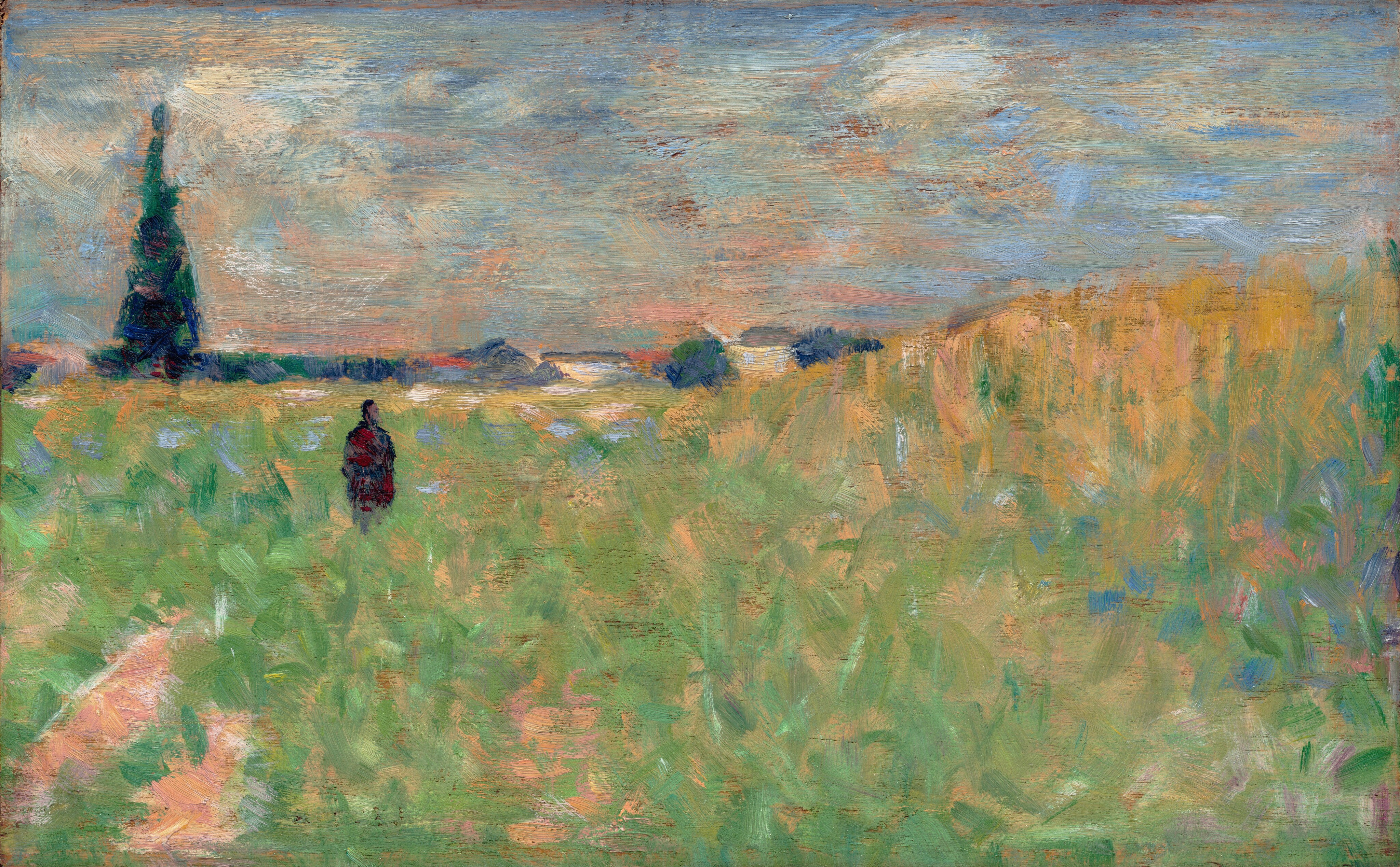 This painting shows an expansive green and yellow grassland under a textured blue and white sky. The horizon line is high, separating the fields and clouds with a thin line of dark trees and small white buildings. The dark silhouette of a small person is in the grass to the left, and a tall tree is in the background on the far-left side. Small dashes of blue and peach paint decorate the grass, and there are streaks of red and peach in the sky. The brushstrokes are short and feathery, giving the scene a blurred quality.