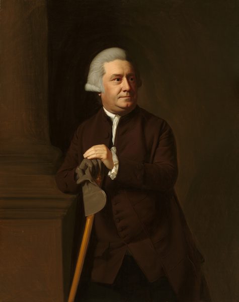 This painting shows a man from the knees up.  His body faces us, while his head is partially turned to the right. He has a round face with light skin and light gray hair combed back from his face and coming down to his ears. He has a straight nose, thin lips, and a double chin. He wears a dark brown coat with a white collar and cuffs and holds a light brown cane. One of his hands is wearing a dark gray glove, while the other is bare; the gloved hand also holds the other glove, along with the cane. The man is leaning against a large brown column that takes up the left side of the painting, and the wall behind him is dark brown.