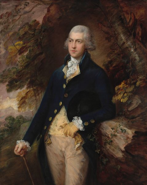 This painting is a portrait of a man standing, seen from the knees up, his torso and head slightly turned to the left. The man has pale skin and gray hair styled back from his face and forming curls around his ears, and he has a sharp nose, thick gray eyebrows, and pink lips set in a neutral expression. He wears a dark blue coat with gold buttons, a pale-yellow waistcoat, and a frilly white cravat at his neck, with more white frills at his cuffs. His trousers are tan. His left arm is bent, resting on a tall rock formation on the right. His left hand is gloved and holds the other yellow glove. His bare right hand holds a thin brown cane. The background features loose leaf shapes in warm autumnal colors, with the gray-brown trunk of a tree visible in the top left and glimpses of a purple and gray sky on the left side. The area behind his head is brown.