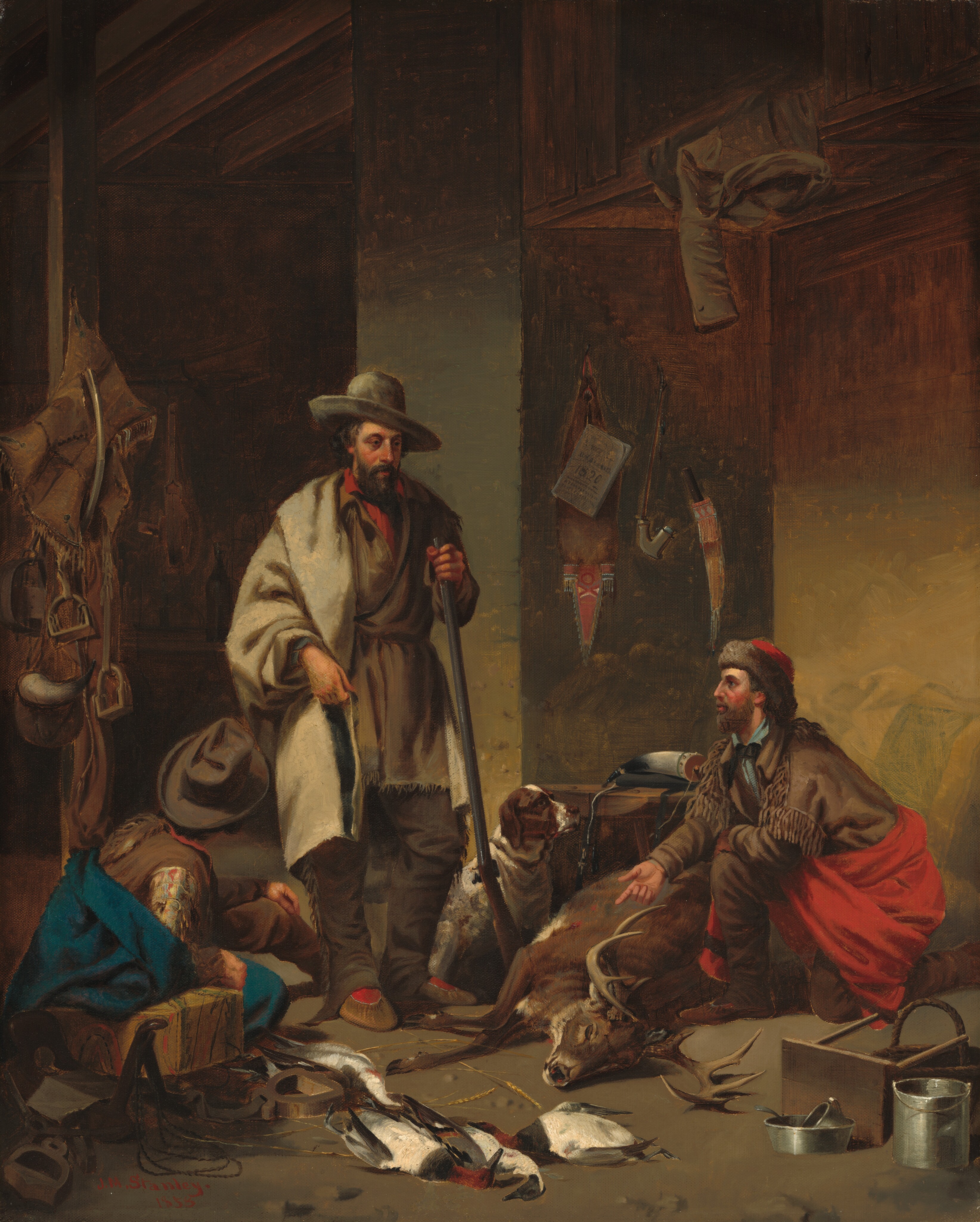 In this painting, three men are depicted in a rustic interior space. A man on the far left faces away from us, sitting on the ground and leaning against a wooden block or stool. He wears a gray hat and a brown vest, and a vivid blue blanket is wrapped around him. He is looking up at a man standing upright near the center of the painting. This man is holding a rifle, the bottom of which rests against the ground. This man has light skin with red cheeks, a long, straight nose, and a dark mustache and beard. His dark hair is hidden by a gray hat, and he wears a light gray coat over a darker gray tunic, with a bright red shirt poking out around his neck. He wears black pants with brown slippers and bright red socks. A white-and-brown dog sits next to his feet. The man on the right is kneeling, and gesturing towards a deer with sizable antlers that lays on the ground. This man has light skin, red cheeks, a light brown beard and mustache, and he looks up at the men across from him. He wears a brown jacket with tassels over a light blue shirt and has a bright red cloth wrapped around his waist over brown pants, as well as a red hat with a brown fur border. The room's walls are painted in shades of dark gray, brown, and yellow ochre, and various tools and leather saddles hang on them. The floor in front of the men is scattered with hunting-related items, such as metal tools and the bodies of small birds.