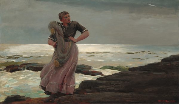 A young woman with flushed, peachy skin stands on a rocky shoreline with a fishing net slung over one shoulder in this horizontal painting. Her body faces us, and she looks off and down to our right. Her left hand, to our right, is planted on her hip, and she clutches the gray net with her other hand. Her head tips toward us as her chin tucks back toward her shoulder. She has a round jaw, a straight nose, and her pink lips are set in a line. Her brown hair is pulled back and up, and bangs sweep across her forehead. Her ash-brown shirt has white bands echoing the neckline, across the waist, and around the hems of the elbow-length sleeves. Her skirt is painted with strokes of mauve pink and silvery gray. A stiff breeze sweeps the skirt to our left and reveals a glimpse of red stockings over sturdy gray shoes. The dark shoreline angles from the lower left corner to halfway up the right edge of the composition. White water breaks over boulders in the surf beyond. Light reflects brightly along the horizon, which comes just over halfway up the painting. A white bird flies in the pewter-gray sky. The artist signed and dated the painting in red in the lower right corner, “Homer 1897.”