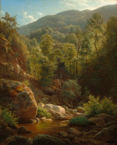 This painting shows a small stream surrounded by brown rocks and green foliage. Golden sunlight illuminates the scene, highlighting the vegetation, trees, hills, and sky in various shades of green, blue, and brown. The water of the stream is clear, showing the brown ground beneath while also reflecting some of the nearby greenery. The sliver of sky above the distant green mountain is bright blue, with a few wispy white clouds.