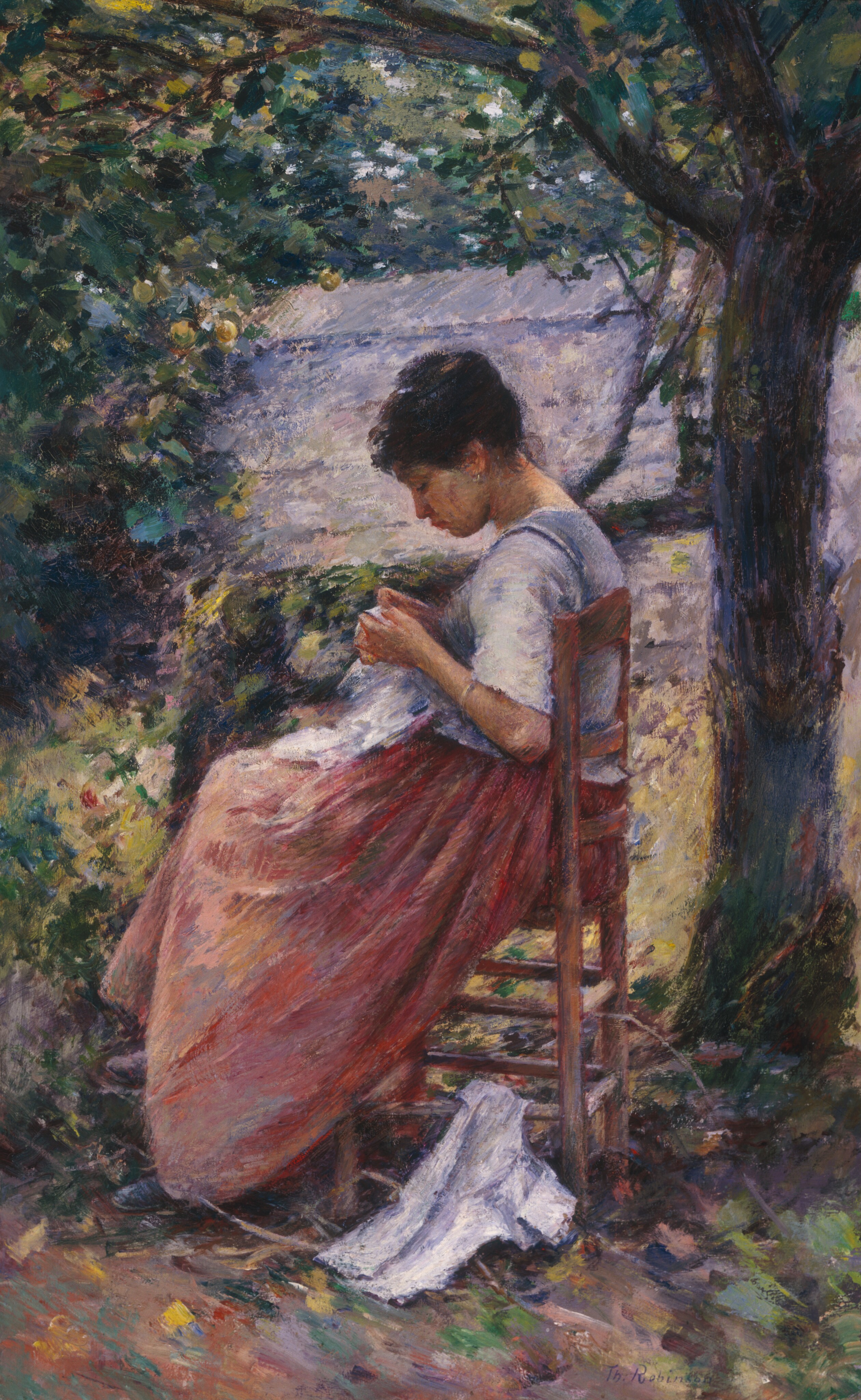 This painting shows a woman seated on a wooden chair outside. She is turned to the left, and we see her in profile. She holds a white cloth in her hands and looks down at it. The woman has pale skin and dark hair styled in a bun on the top of her head, and her legs are crossed. She wears a dress with a white bodice and pink skirt. There is a small hoop earring in her ear and a bracelet on her wrist. On the ground by her feet is another piece of white fabric. She sits by a large tree on the right side of the painting and is surrounded by green leaves and yellow grass. Small areas of blue sky are visible through the canopy of leaves above her. Behind her, the roof and side of a building are visible.