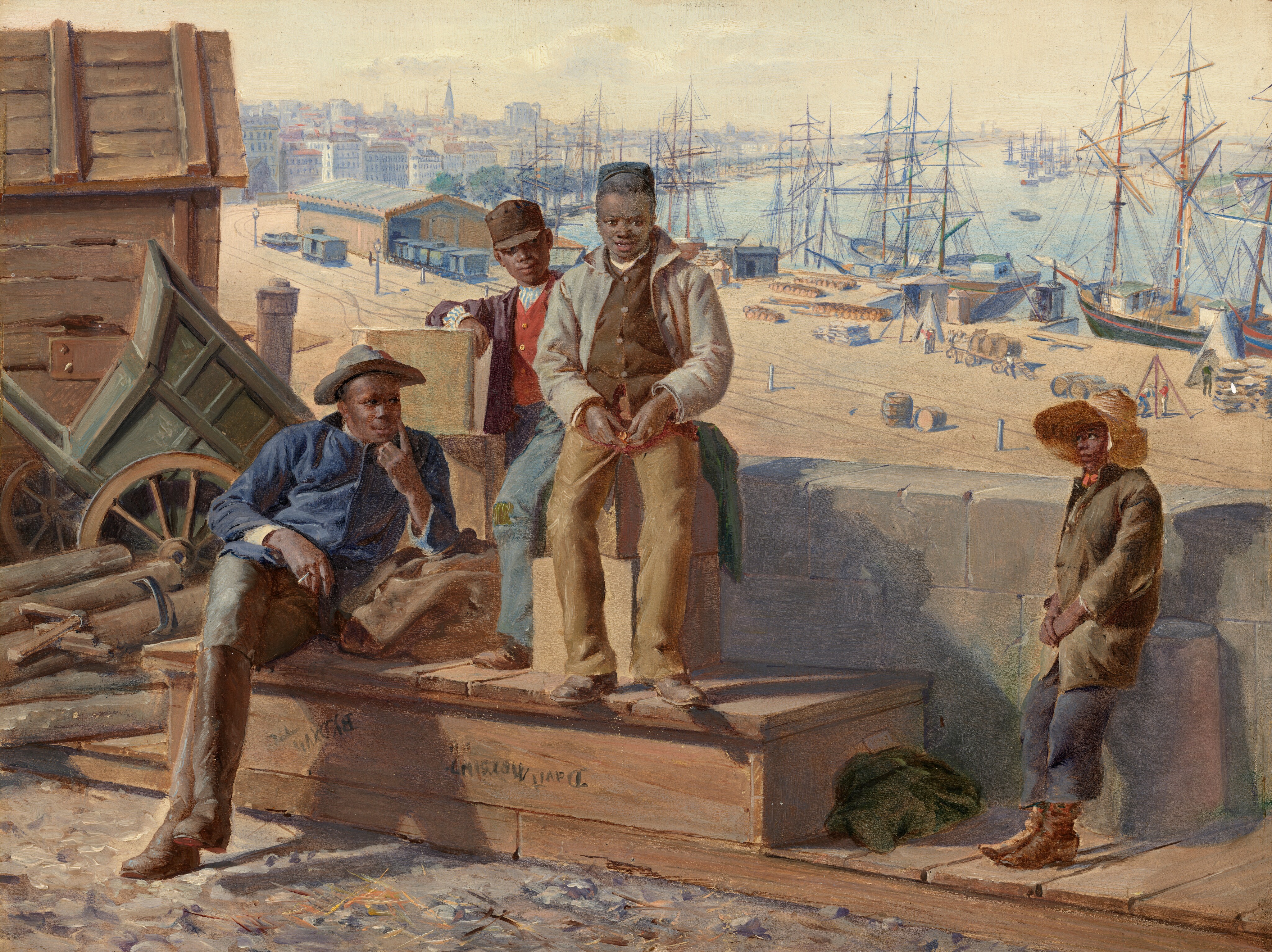 The painting depicts four boys, sitting or leaning against boxes, a wooden platform, and a stone wall. The boy on the left is sitting on the wooden platform, leaning back with his legs crossed, and wearing a blue shirt, brown pants, and a wide-brimmed hat. Next to him, standing on the same platform and sitting on stacked boxes, are two of the other boys. One of these boys is wearing light-colored trousers and a buttoned-up vest underneath a light-colored jacket. The other boy stands slightly behind him, dressed in a red shirt, a dark vest, and a dark jacket, with a brown hat. The last boy, standing to the right and leaning against a low stone wall, is wearing dark-blue trousers, a brown jacket, and a wide-brimmed straw hat. All of the boys have brown skin and short, dark hair. The background showcases a bustling harbor scene with numerous docked sailing ships, buildings, and equipment, all under a pale gray sky.