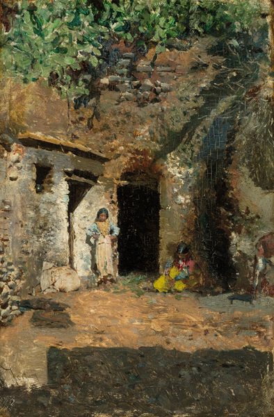 This painting depicts a white stone structure with a brown and gray roof surrounded by greenery and foliage. The walls and roof of the building are textured with the outlines of small stones, and the wall of the building directly across from us has a dark doorway at its center. Two people are visible on either side of this doorway. On the left, a person with light brown skin and short black hair stands with their hands on their hips. They wear a blue shirt and cream-colored pants, with a large tan necklace or garland around their neck. On the right, another person sits against the wall, wearing a bright yellow garment with pink and blue sleeves. They also appear to have light brown skin and black hair put up into two small bunches. Greenery hangs above the roof of the building, and the ground is depicted in dusty earth tones. The brushstrokes in the painting are thick and visible, and details, especially those in the people, are suggested with daubs of paint.