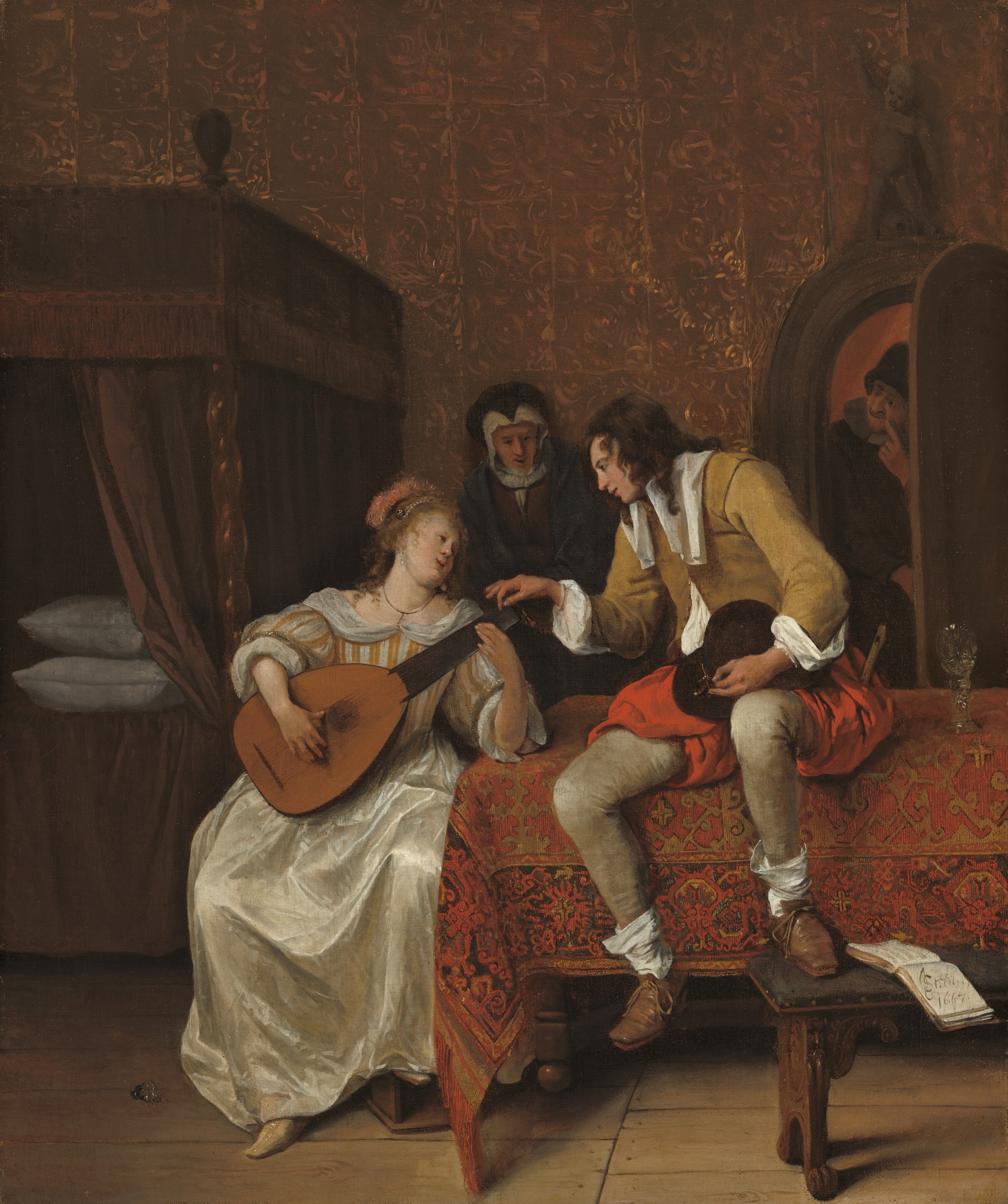 A woman playing a lute sits next to a table, on which a man perches and leans toward her in this vertical painting. Two people look on from the background. All the people have pale skin. The table is covered by cloth patterned in brick red, fawn brown, and black, and it extends off the right edge of the painting. The woman sits along the narrow end of the table to our left of center. Her body faces us as she holds the lute in her lap, one foot resting on a small wooden box. Her left elbow, to our right, is propped on the table to hold the neck of the lute. Her curly, blond hair is pulled back under a string of pearls and a fuzzy salmon-pink cap, or a feather, covers the back of her head. The bodice and puffy, elbow-length sleeves of her gown have cream-white and peach-colored stripes, and the ivory-white satin skirt falls to her feet. She wears a thin gold necklace and pearl earrings. With lips parted, she turns her face up to look at the cleanshaven man sitting on the table next to her. The man’s brown curls fall loosely over his shoulders. A long, wide white collar hangs down the front of his mustard-brown jacket. The voluminous white shirt he wears underneath shows where the jacket is unbuttoned near his waist and at his cuffs. He wears thigh-length, red pantaloons and close-fitting tan leggings. Baggy white socks hang around his ankles, and his brown shoes are tied with laces. A wooden flute sticks out of the pocket farther from the woman, and he holds a tall black hat in his lap, cradled in his left hand, to our right. With his other hand, he reaches to pluck a string near the peg board of the lute. One foot dangles off the edge of the table, and the other is propped on a bench, next to an open book. A glass with a tall stem and rounded bowl sits on the table next to him. Farther back in the shadows of the room, an older woman looks toward the couple, perhaps at the man’s hand on the lute, with her mouth slightly open. A white bonnet frames the woman’s face, and she wears a black hood and cloak over her dark dress. A bed under a box-like canopy sits along the back wall, and is cut off by the left edge of the painting. Dark curtains hanging from the canopy are pulled back to show two white pillows laid one atop the other. Also at the back of the room, to our right, a man peers in through a half-opened, arched door. He wears a conical, black, brimless hat and has a white collar over a dark coat. He looks toward the older woman with one index finger held to the corner of his grinning mouth. The wall is covered with gold-embossed, brown leather squares. The artist signed and dated the painting as if he had written in the open book on the bench: “J Steen 1667,” with the letters J and S entwined.