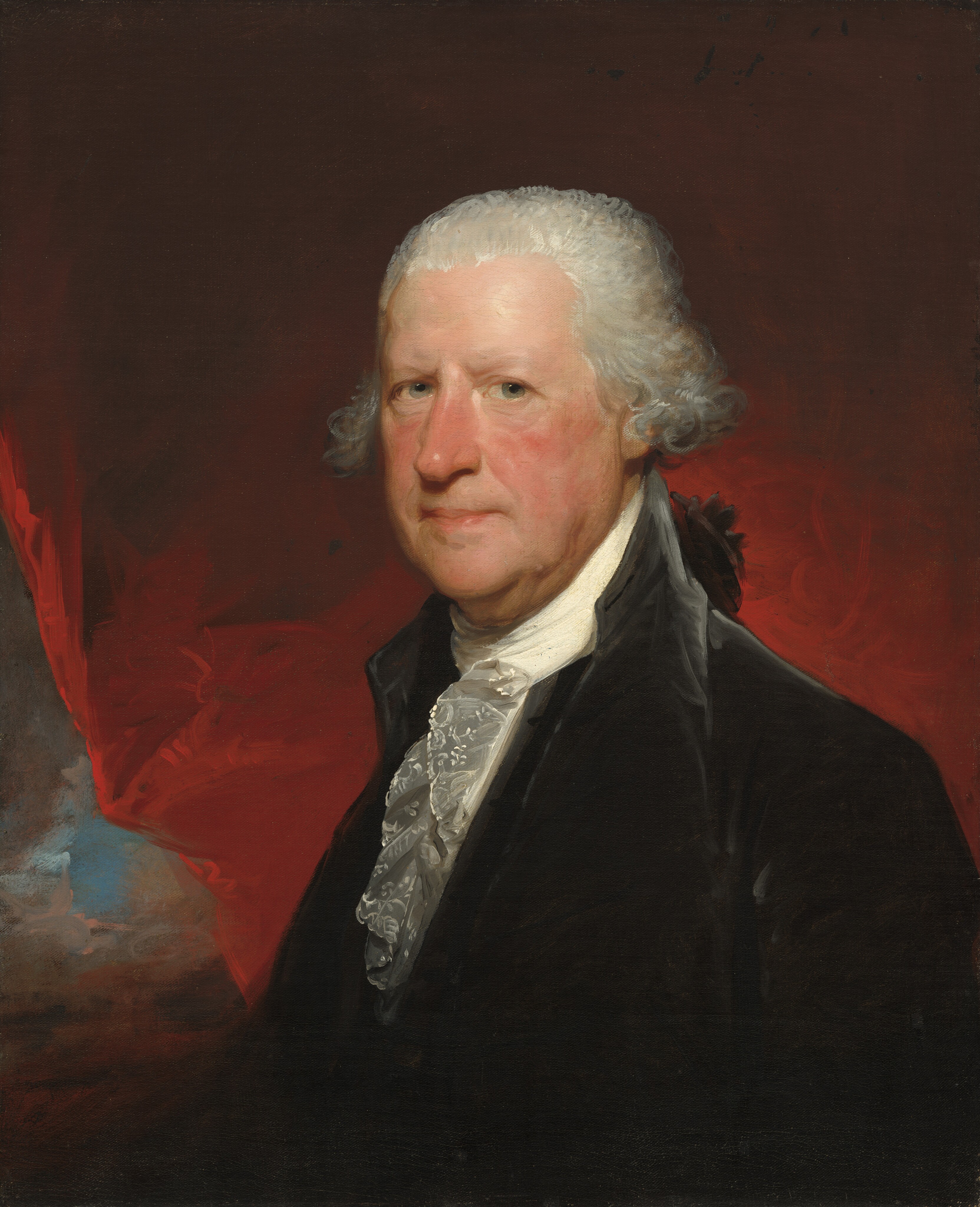 The image shows a portrait of a man's upper body, focusing on his head and shoulders. The man is facing slightly to the viewer's right, with his head turned toward the viewer. He has fair skin, flushed cheeks, prominent cheekbones, and a calm expression. His white hair is styled in 18th-century curls. The man is wearing a dark formal coat with a high collar and a white cravat around his neck. The background is a blend of rich red tones with hints of blue and brown, adding depth to the composition. No jewelry or objects are visible.