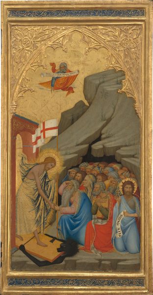 A bearded man, Jesus, strides from under an archway across a wooden door that lies flat along the ground as it pins and crushes a black beast in this vertical, framed panel. A crowd of people huddle inside the rocky cave, and everyone has pale skin faintly tinged with green. Jesus wears a bright, gold-patterned cloth draped over one shoulder and around his body. He holds a tall pole with a flag with a red cross on a white field with his left hand. His other clasps hands with an elderly man with gray hair and long white beard. Behind the elder man, a crowd of men and women kneel in front of the opening of a craggy cave. One man holds a scroll with black letters that reads, “ECCE ANGIUS.” Another bearded man floats above holding a scroll that reads, “DESTRUXIT QUIDAM MORTES INFERNI ET SUBVERTIT POTENTIAS DIABOLI.” Above the scene, an architectural arch and tracery is created in low relief in gold against the gold-leaf background. The gold frame has inset bands of lapis blue with scrolling, leafy designs in gold above and below the central scene.