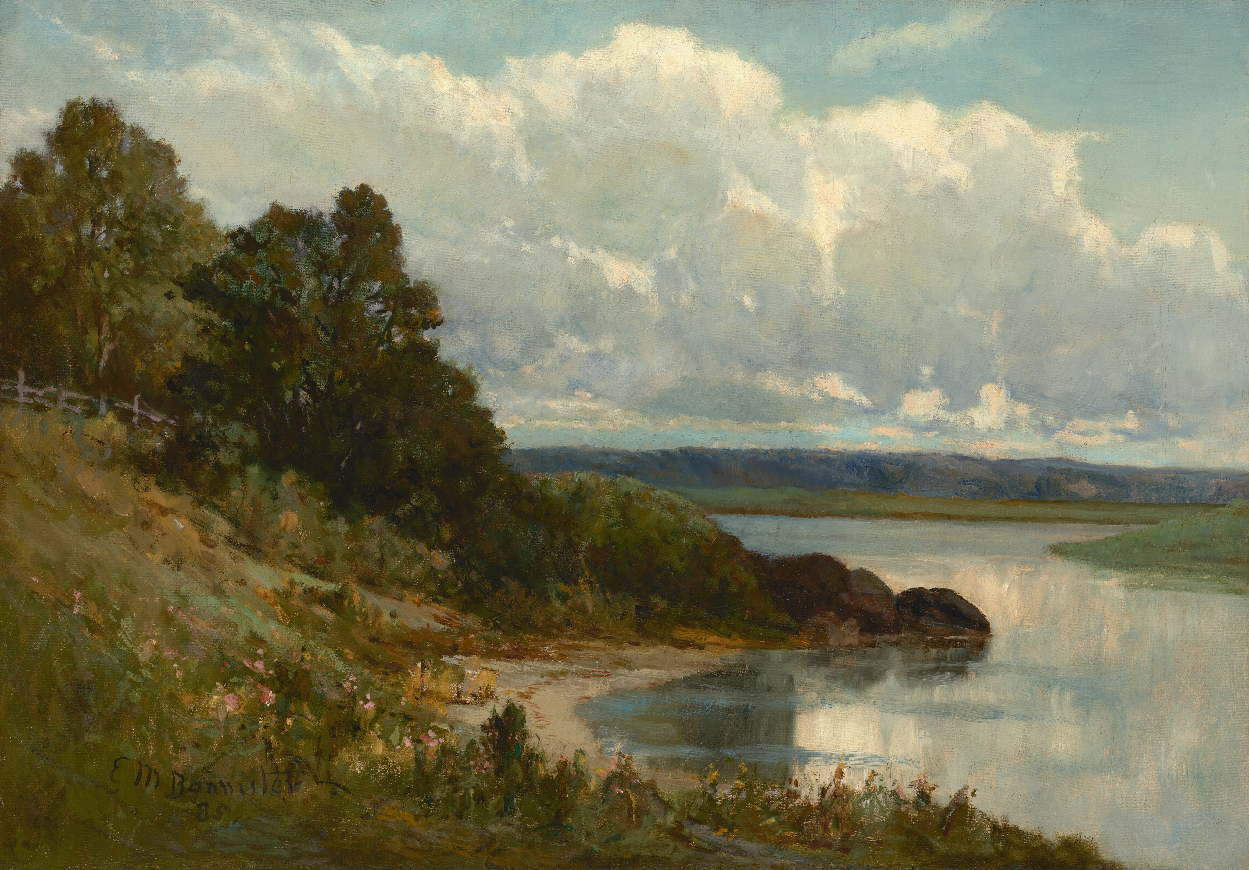 The painting is a landscape featuring a riverbank with tall, dark-green trees on the left side and distant blue hills in the background. The shore on the left is covered is tall yellow and green grass and dotted with pink and white flowers below the dark green trees. The water on the right is light blue, reflecting the blue sky and the thick white clouds.