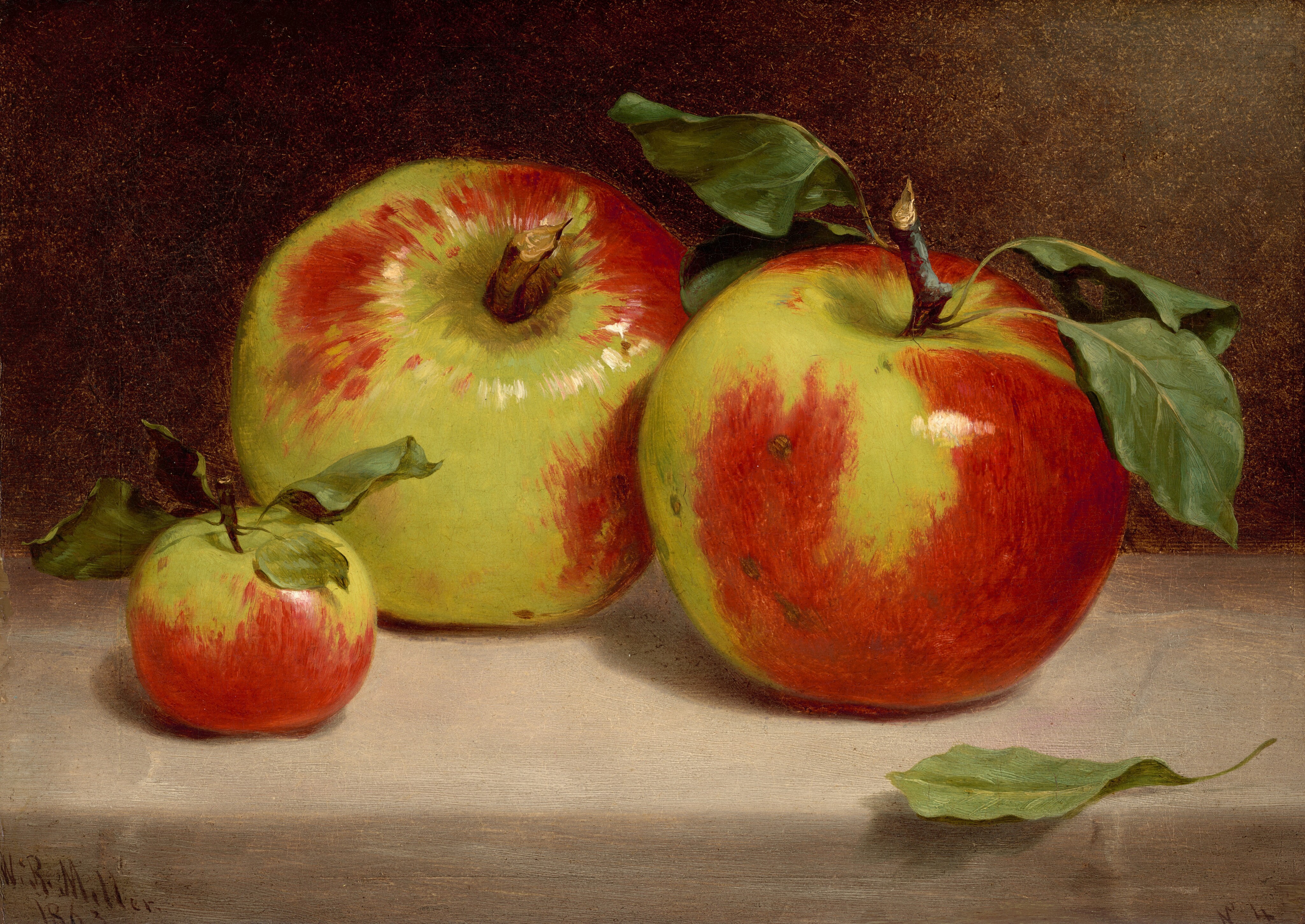 This painting shows three apples on a flat, gray surface. Two of the apples in the center are large, while one to the left is much smaller. The apples are glossy, covered in uneven patches of bright red and light green. Two of them have wide, dark-green leaves attached to their brown stems. One stray leaf lies on the gray table at the bottom right. The wall behind the apples is muted brown, with a lighter area in the top right corner.
