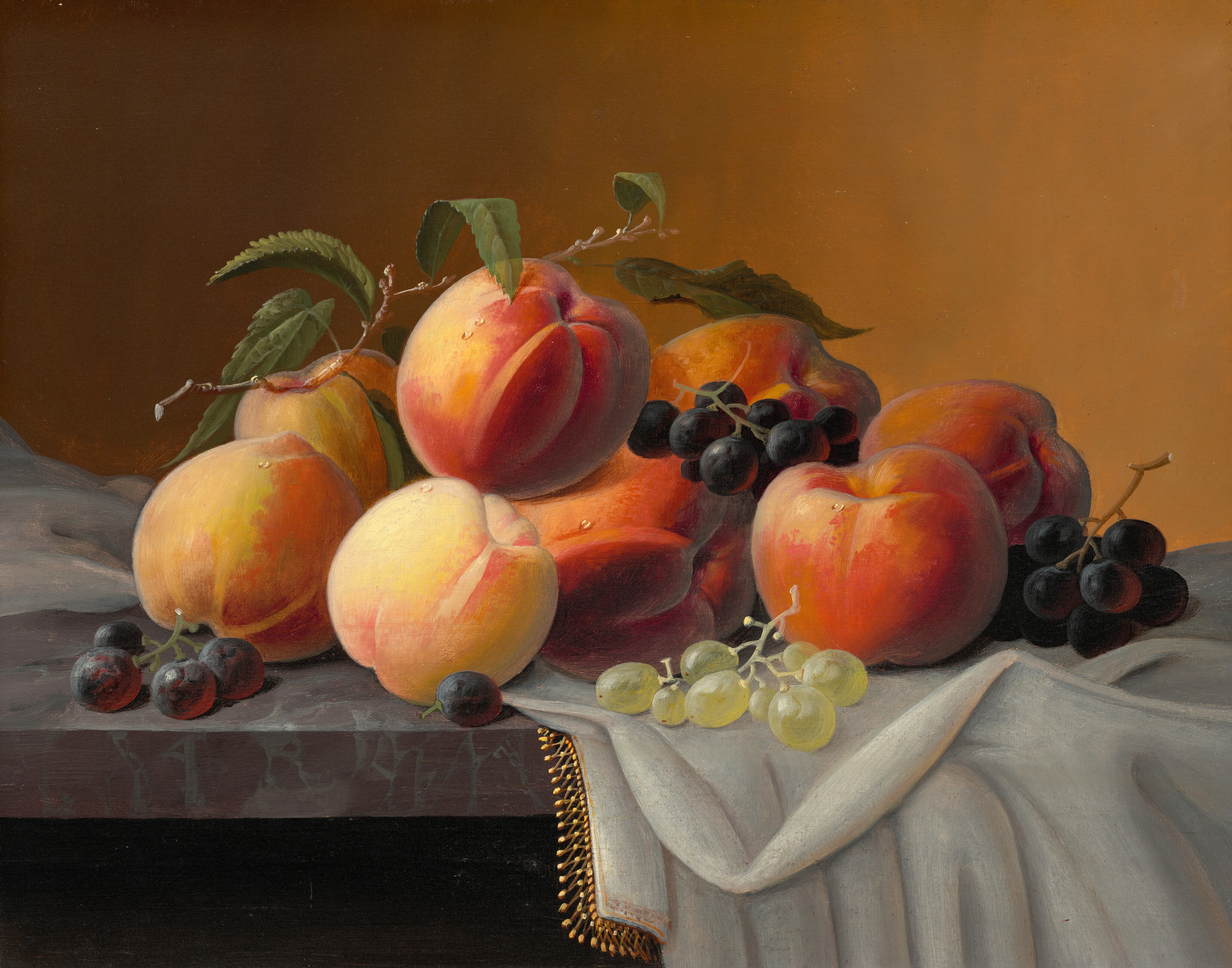 This painting shows a collection of ripe peaches and clusters of grapes arranged on a table. The peaches have hues of orange, pink, and yellow, while the grapes are dark purple and light green. Several peaches are stacked closely together in the center, with the grapes on top of them and around them. A thin stick with green leaves rests on top of the stacked peaches. The table they lie on appears to be a dark red-and-gray marbled surface, with a white cloth edged in gold draped over the right side. The wall behind the fruit is a gradient, with brown on the left side fading into pale orange on the right side.