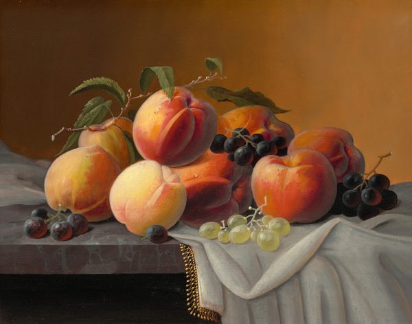 This painting shows a collection of ripe peaches and clusters of grapes arranged on a table. The peaches have hues of orange, pink, and yellow, while the grapes are dark purple and light green. Several peaches are stacked closely together in the center, with the grapes on top of them and around them. A thin stick with green leaves rests on top of the stacked peaches. The table they lie on appears to be a dark red-and-gray marbled surface, with a white cloth edged in gold draped over the right side. The wall behind the fruit is a gradient, with brown on the left side fading into pale orange on the right side.