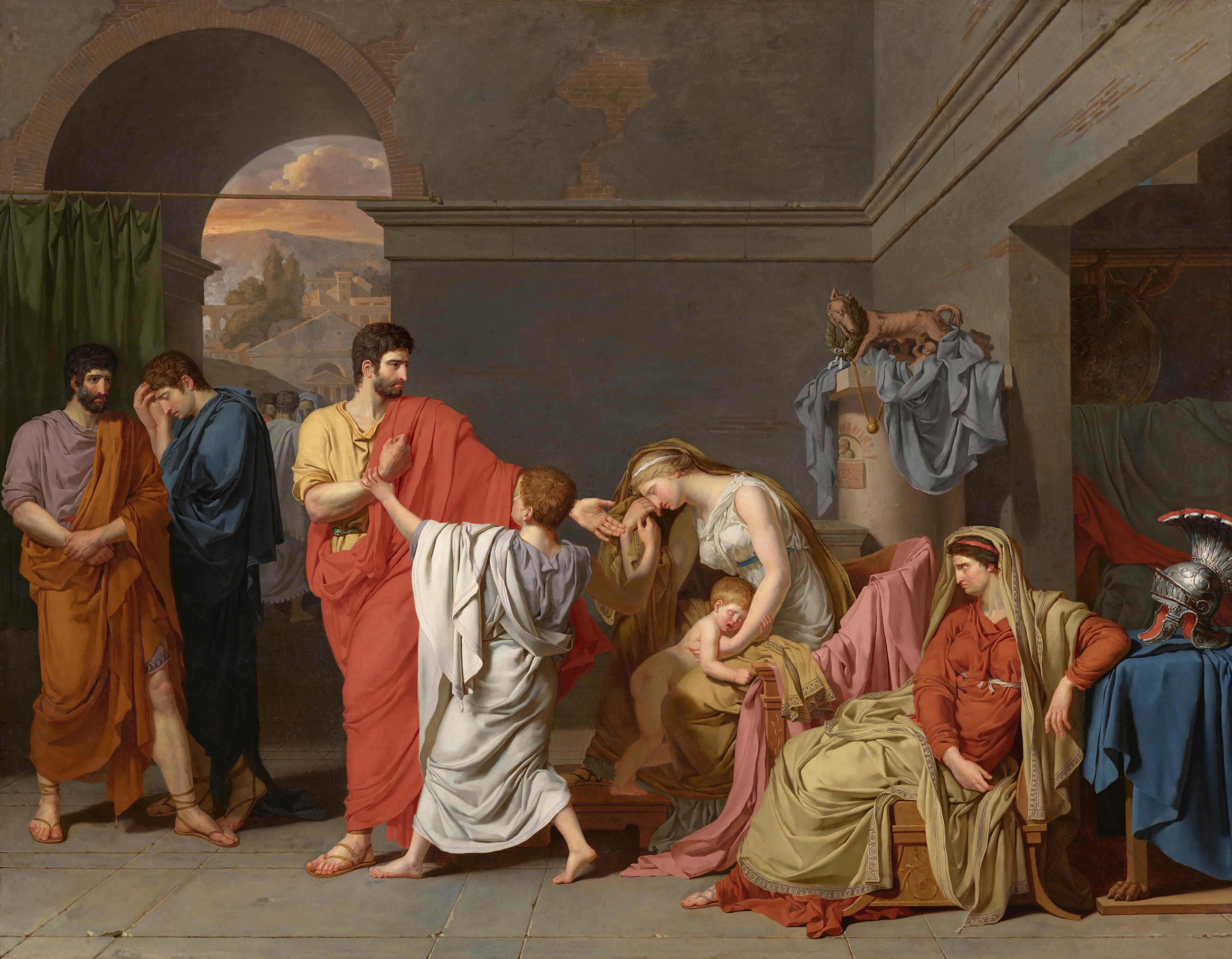 This is a painting featuring multiple people in an interior setting. To the left of the center, a bearded man stands, wearing a long red robe draped over a yellow shirt or tunic. His body faces us, but his head is turned to the right, where he gestures with one outstretched hand. In front of him, a crying child in a pale blue robe has his back to us and grabs the man's other wrist. The standing man is gesturing towards a seated woman the right, who has her head resting on one hand, a tear falling down her face and her eyes closed. She is wearing a white dress with a yellow shawl that drapes over her blonde hair and down her back. A naked crying child stands between her legs, clinging on to her arm. On the far right is a second seated woman who wears a red dress with a similar yellow shawl. This woman has dark brown hair, and she looks up towards the standing man from under furrowed brows. She, too, is crying. Her left arm rests on a table behind her which is draped with a blue cloth. On top of this table is an ornate silver helmet with a red interior and a large silver plume topped with red. On the far left, two men stand in front of a green curtain. One of them is turned away from the central man and has his head in his hands. He wears a blue robe. The other man has a dark beard, and he looks toward the central man, his brows furrowed and eyes wide. He wears a light purple tunic with an orange cloth over it. All of the people in the painting have pale skin. The ground beneath the people is made of rectangles of blue-gray stone, and the walls are light blue, with the plaster or paint chipped in places to reveal brown bricks. On the right, beyond the table with the helmet, there is an opening into another room. To the left of this opening is a short white column with a small reddish-brown statue of a wolf on it. In the upper left corner is an arched opening that leads outside, where another cluster of people is visible, along with white buildings, olive green trees, a tall gray mountain, and a cloudy sky in shades of yellow, orange, and pale purple.