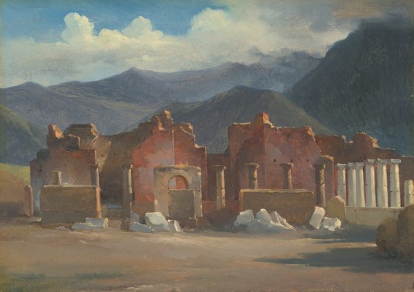 This painting shows ancient ruins made of reddish-brown stone. In front of these dilapidated walls are lines of tan and gray columns and free-standing arches. The brown ground is littered with cream-colored stones. In the background, there are rolling gray hills and distant mountains under a blue sky with fluffy white clouds.