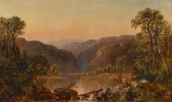 The painting features a valley with purple and brown mountains in the distance, surrounding a reflective body of water with a small rowboat floating on it. Closer to us, there are gray rocks, brown tree trunks and branches, and lush green vegetation at the edge of the water. The sky above is painted in warm shades of yellow, peach, and orange, which transition to pale greenish-blue at the top. The water below reflects these colors, as well as those of the distant mountain and surrounding trees.