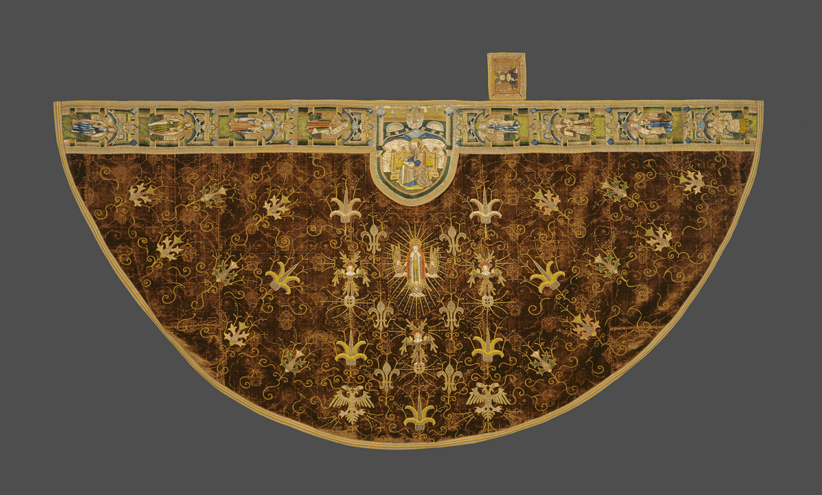 Half circle of fabric, embroidered with Virgin Mary, saints, prophets, and plant motif.