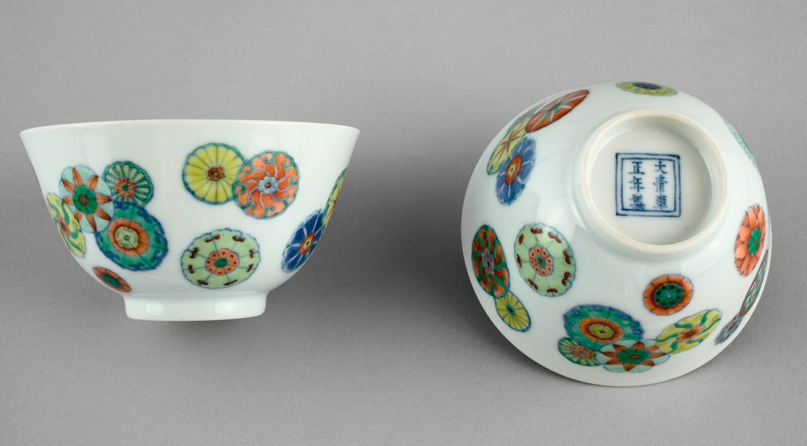 Small white porcelain cups with circular patterns and no handles.