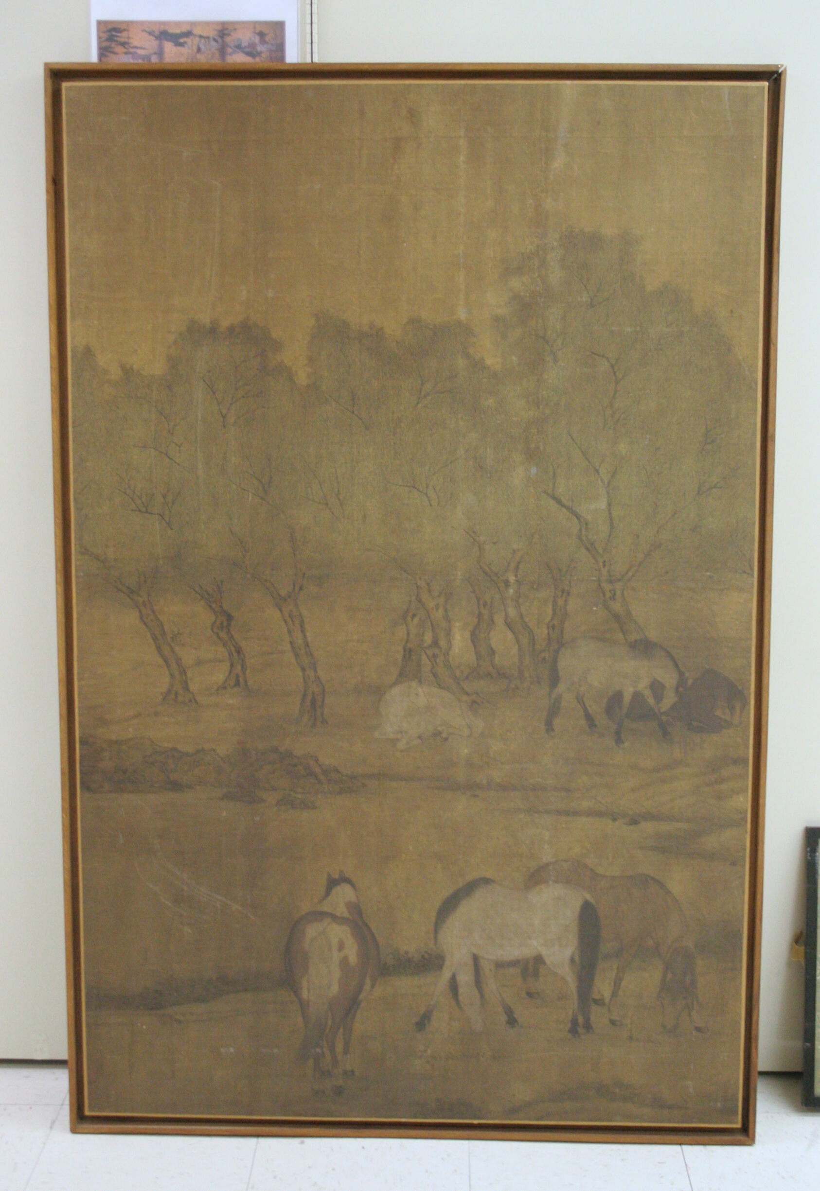 A work made of ink and light color on silk.