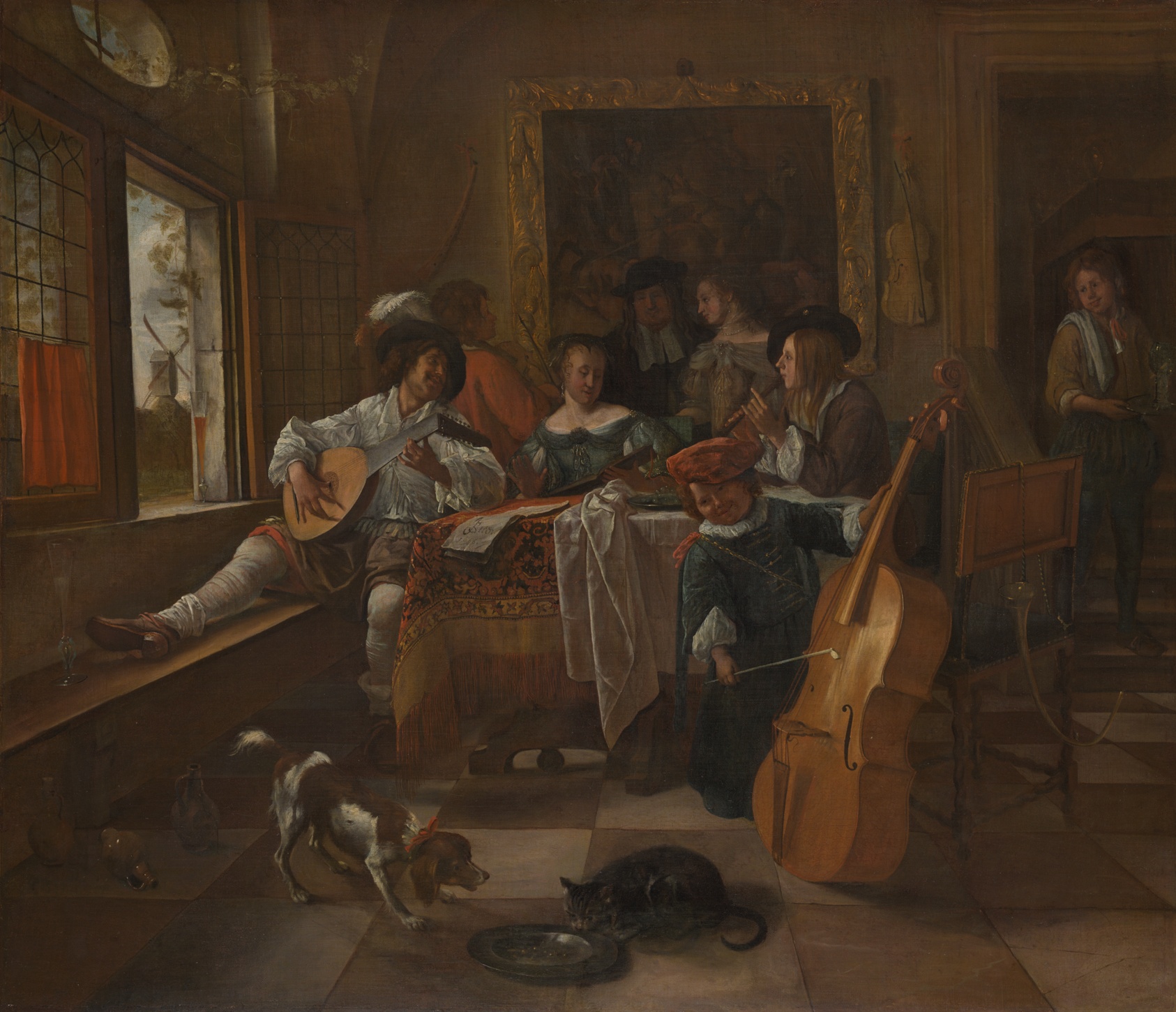 Painting of several light-skinned people gathered around a table in front of a gilded mirror, playing instruments. At left, seated next to a woman in an off-the-shoulder gown, a man in a plumed hat plays a lute. At center right, another man plays a cello, while a dog and cat eat from a dish underfoot.