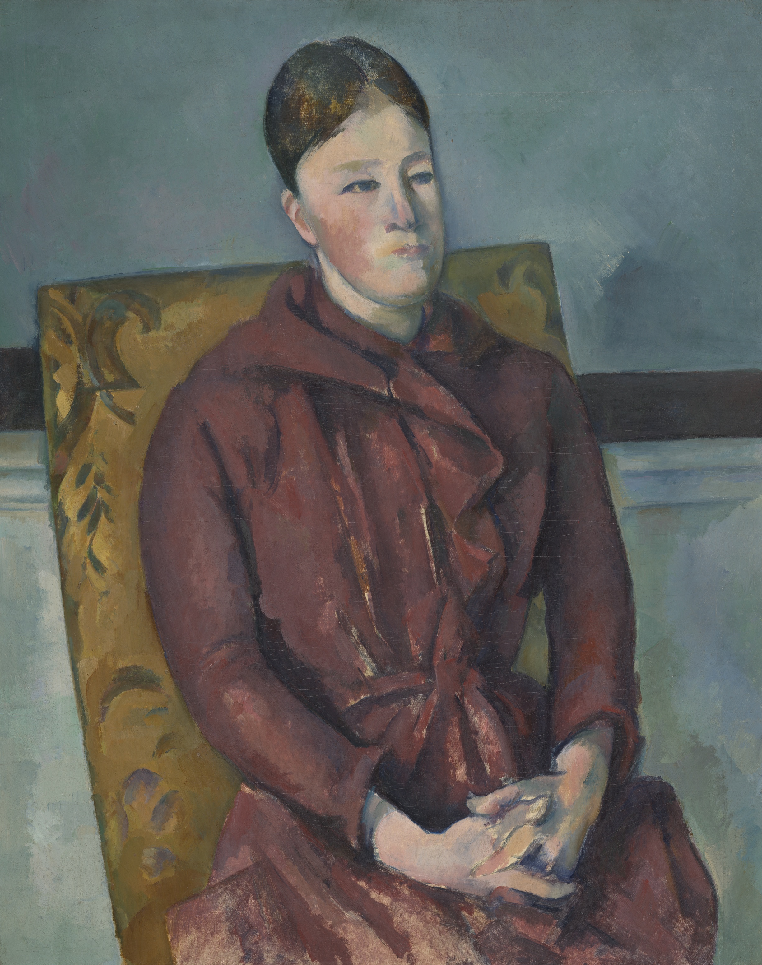 Painting of a placid-looking, light-skinned woman in a maroon dress, seated in a chair with yellow upholstery, hands folded.