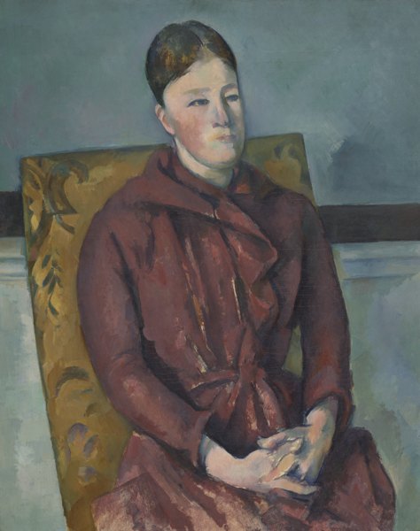 Painting of a placid-looking, light-skinned woman in a maroon dress, seated in a chair with yellow upholstery, hands folded.