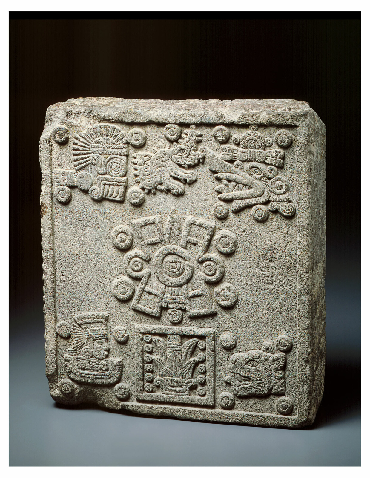 Large plaque of stone carved with animal and geometric hieroglyphs.
