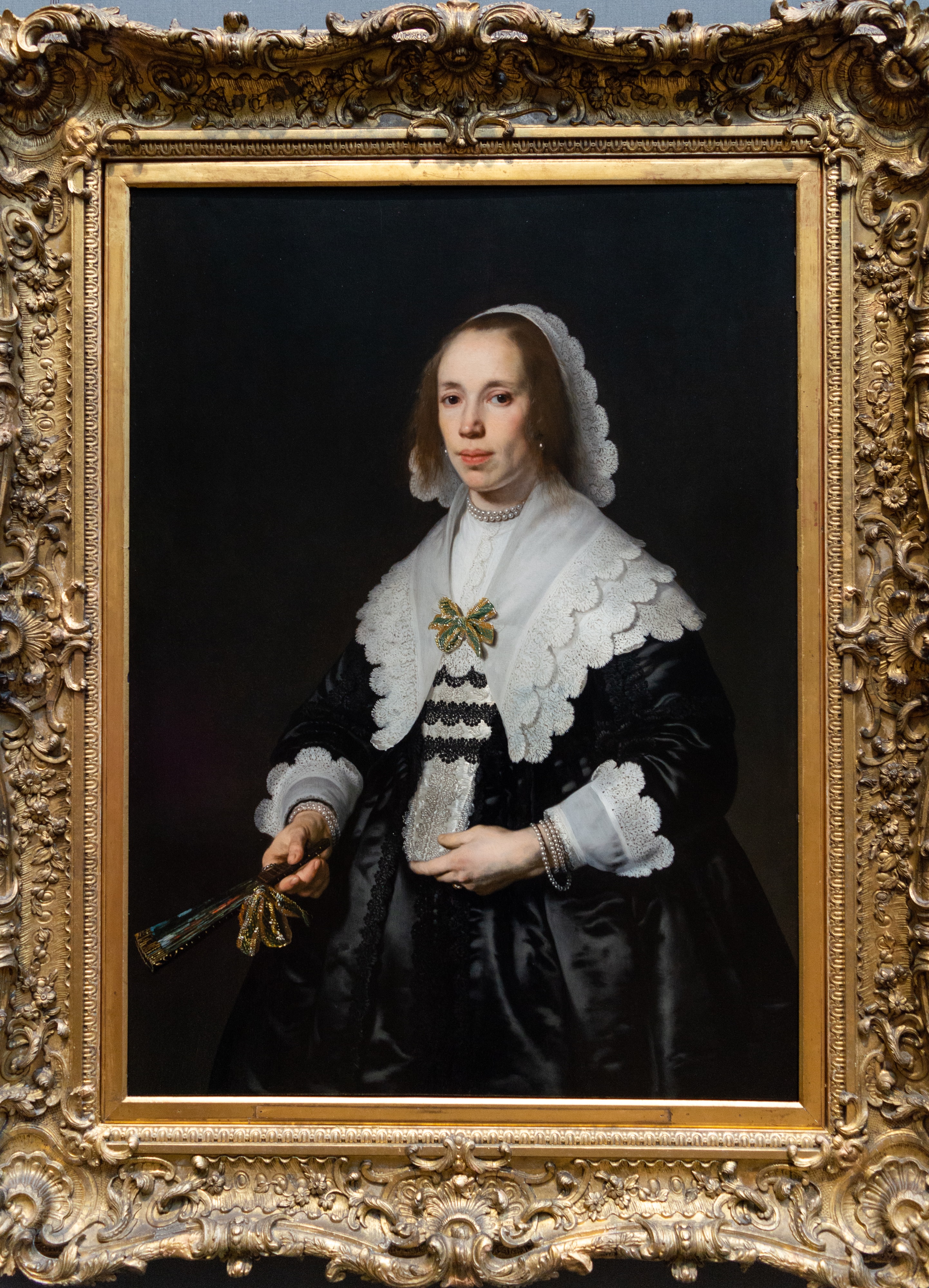 Portrait of a Lady in Black Satin with a Fan by Bartholomeus van der Helst