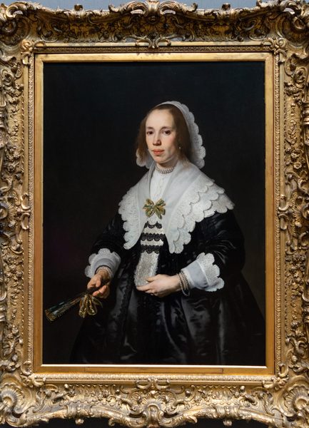 Portrait of a Lady in Black Satin with a Fan by Bartholomeus van der Helst